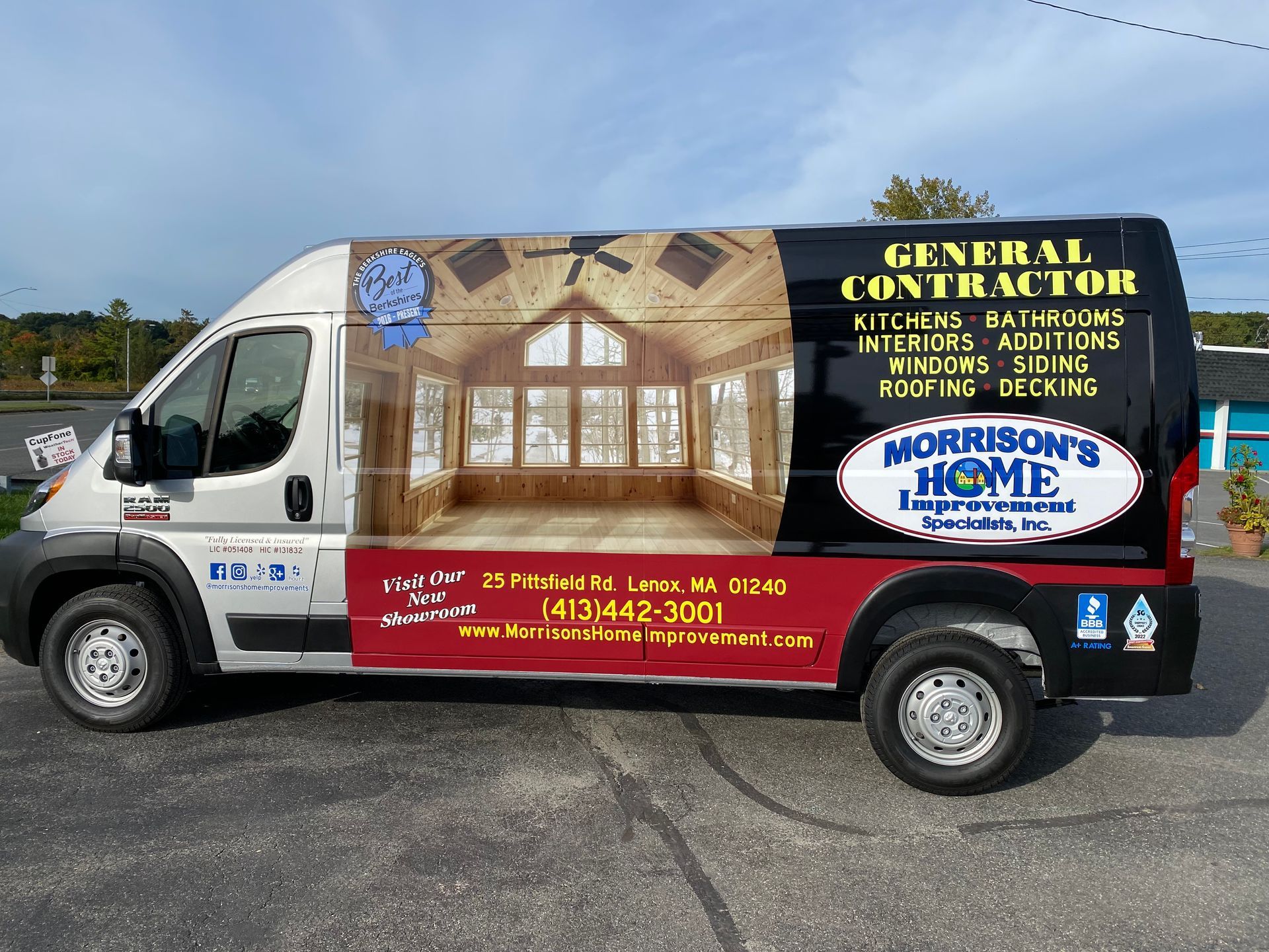 A general contractor van is parked in a parking lot