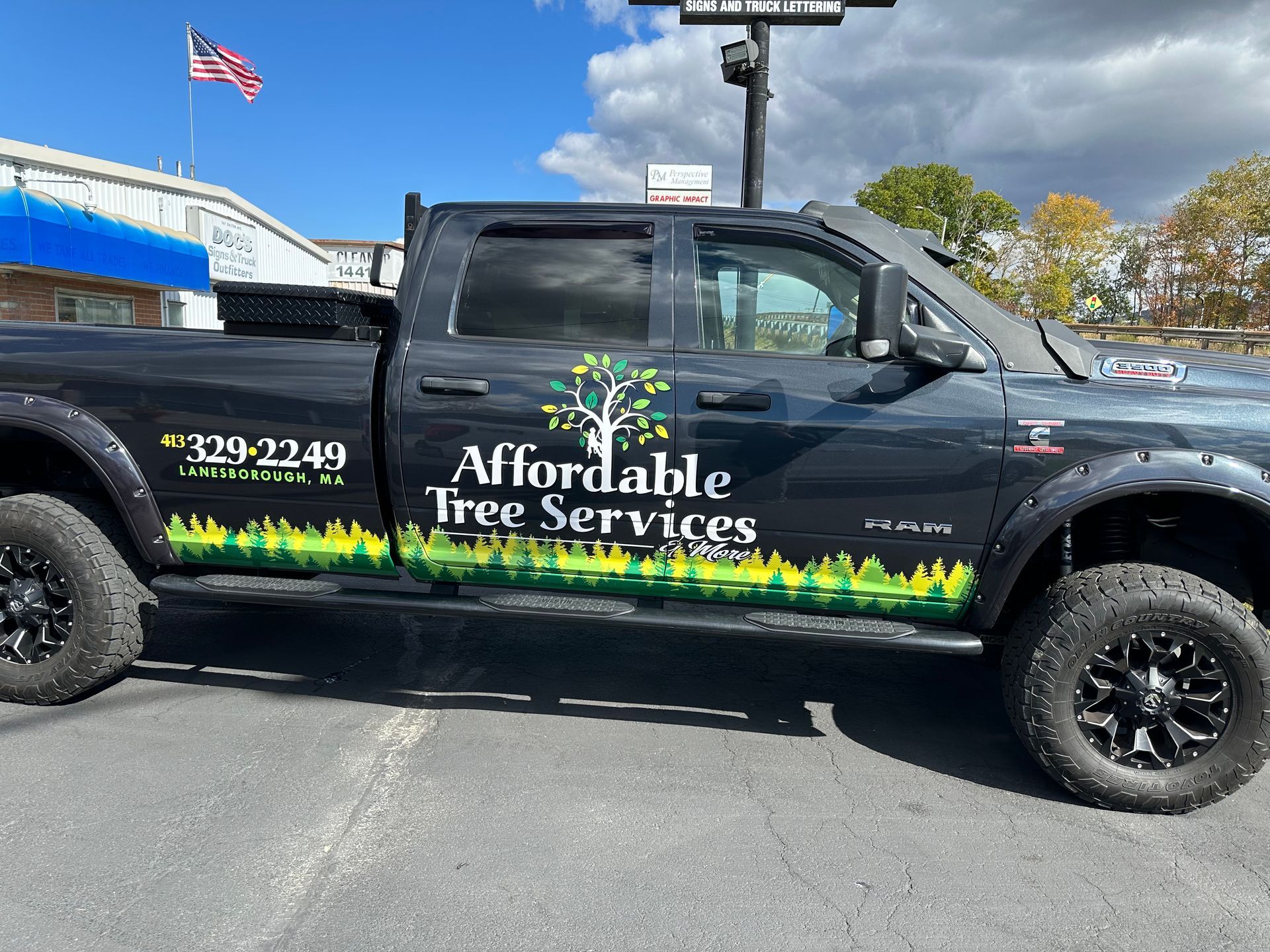 A black truck with a sticker on the side that says affordable tree services