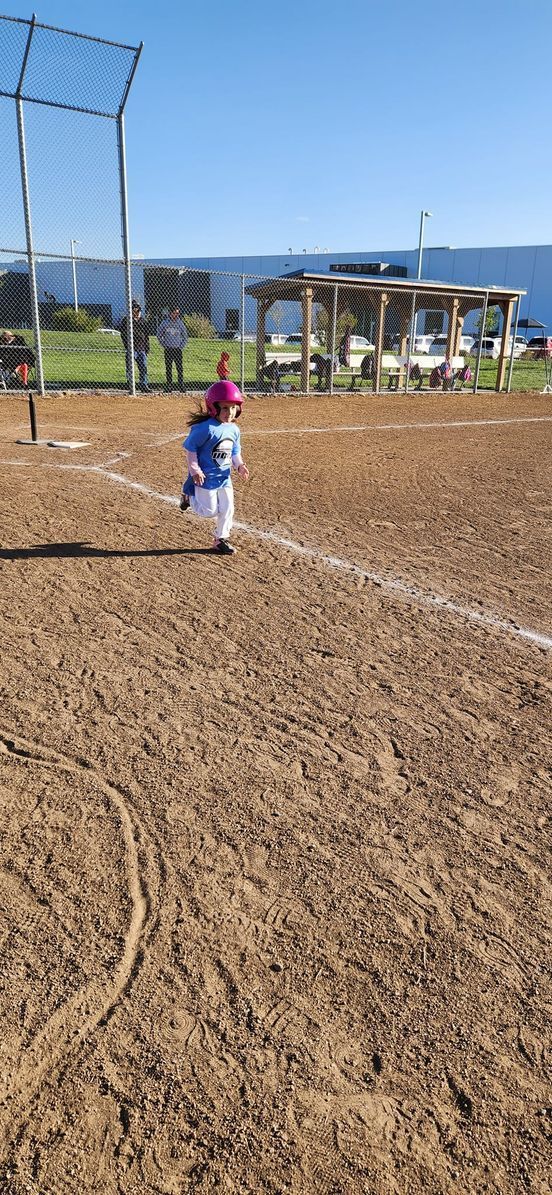 A child running on a baseball field
