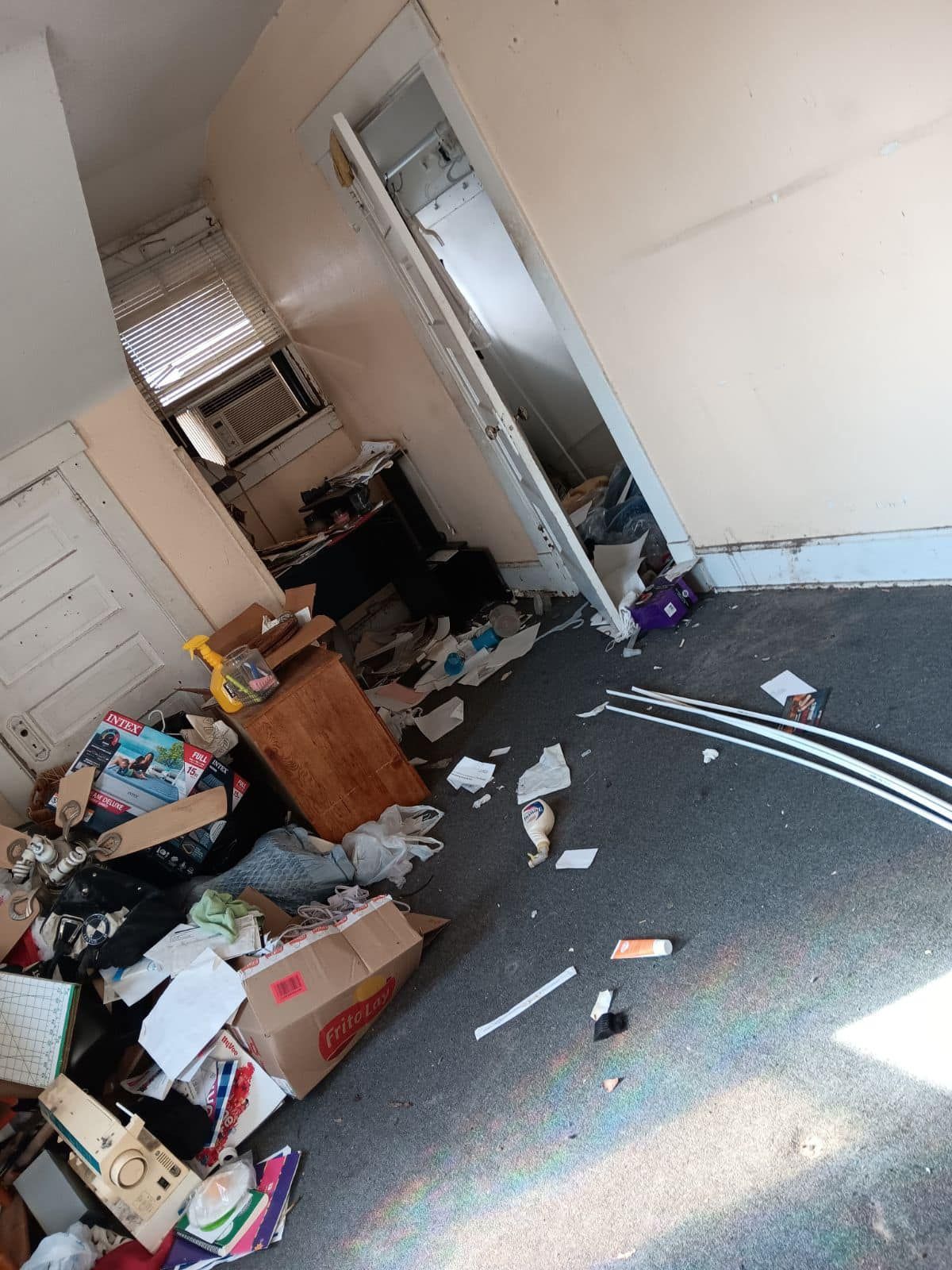 room floor with trash that blocked door