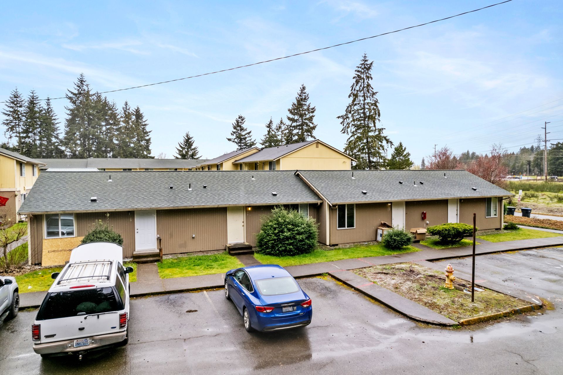 A blue car is parked in front of a building