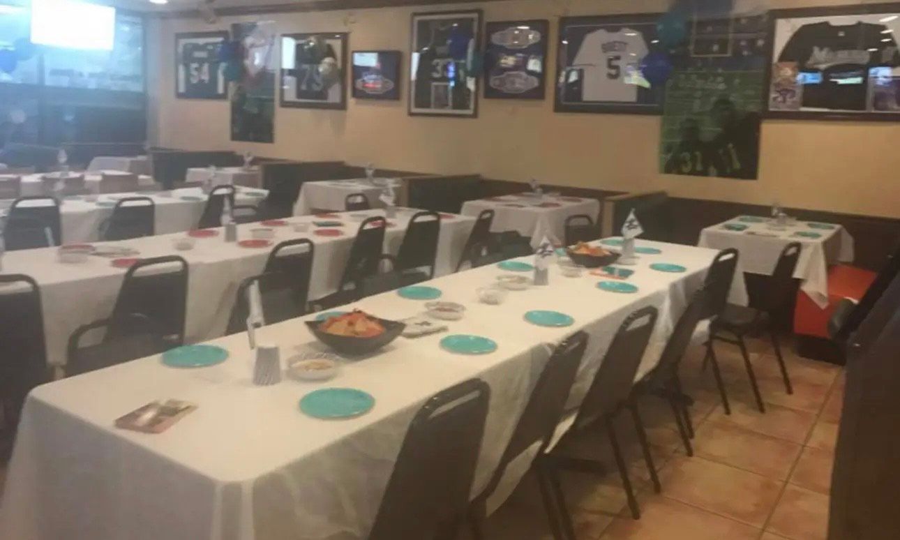 A restaurant with tables and chairs set up for a party.