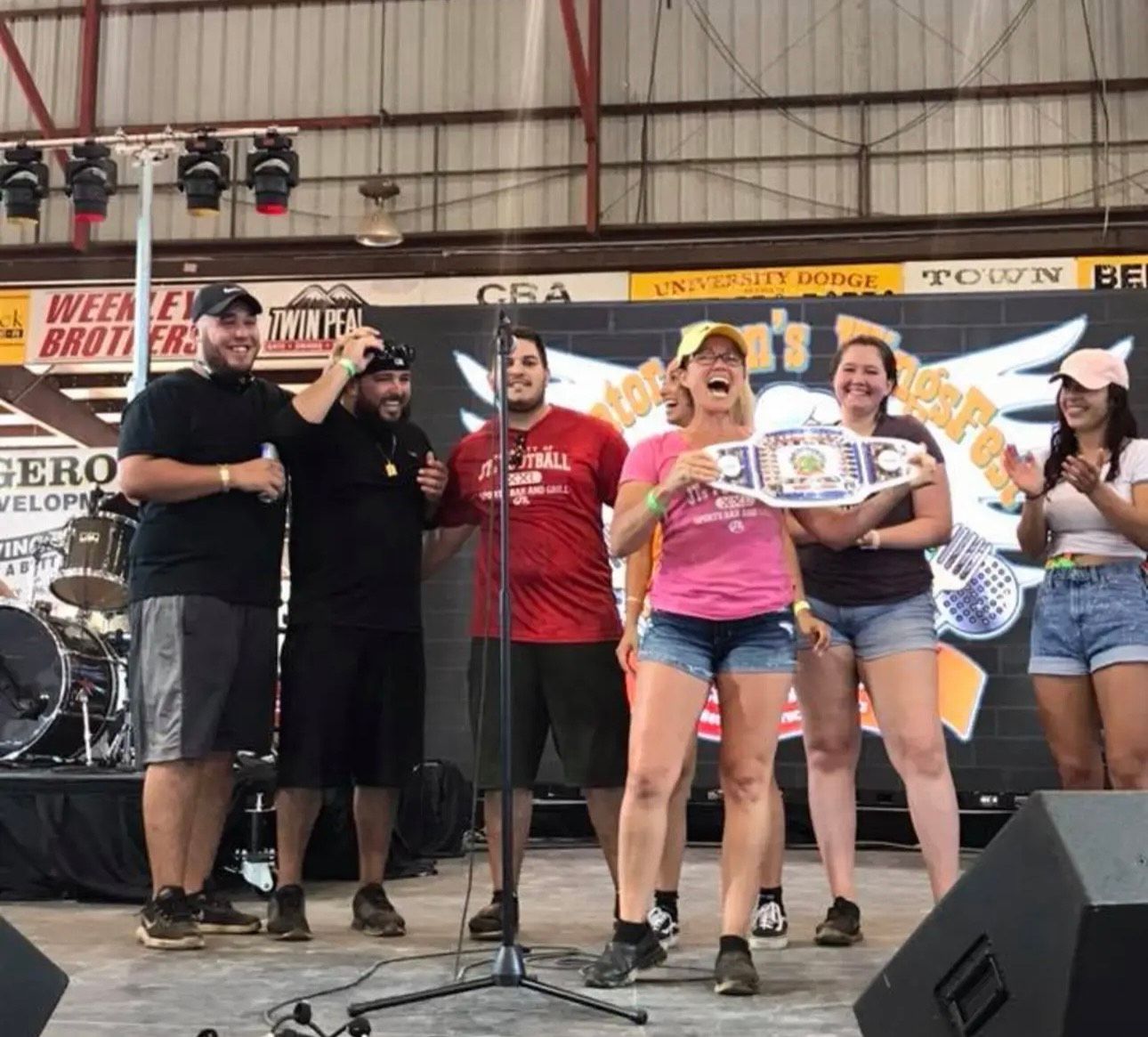 A group of people standing in front of a microphone on a stage