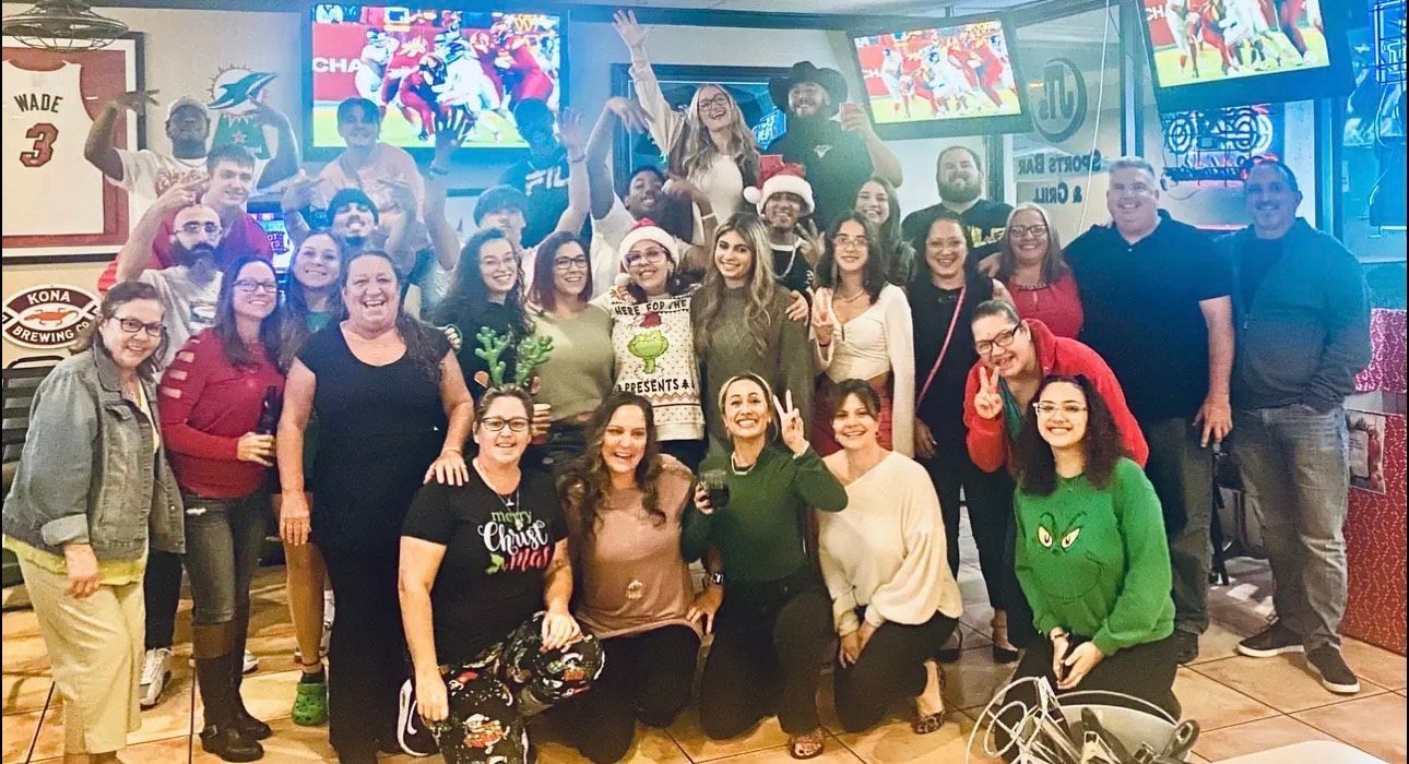 A group of people are posing for a picture in a restaurant.