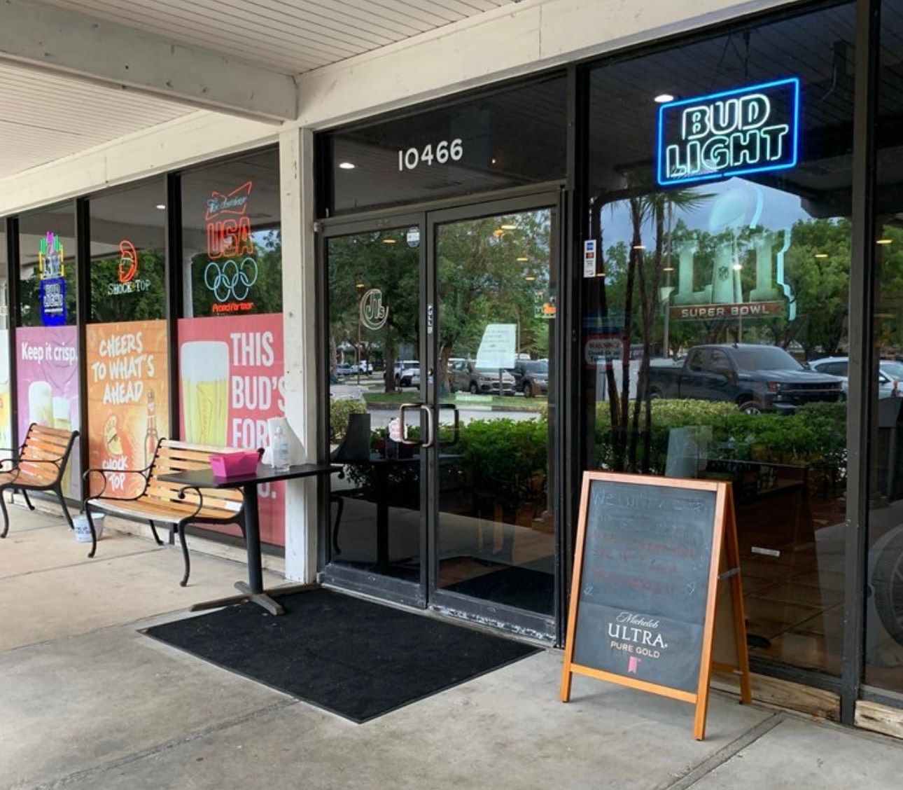 A store front with a sign that says bud light on it.