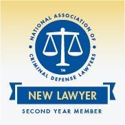 Logo for National Association of Criminal Defense Lawyers: blue scales of justice, circle text, 