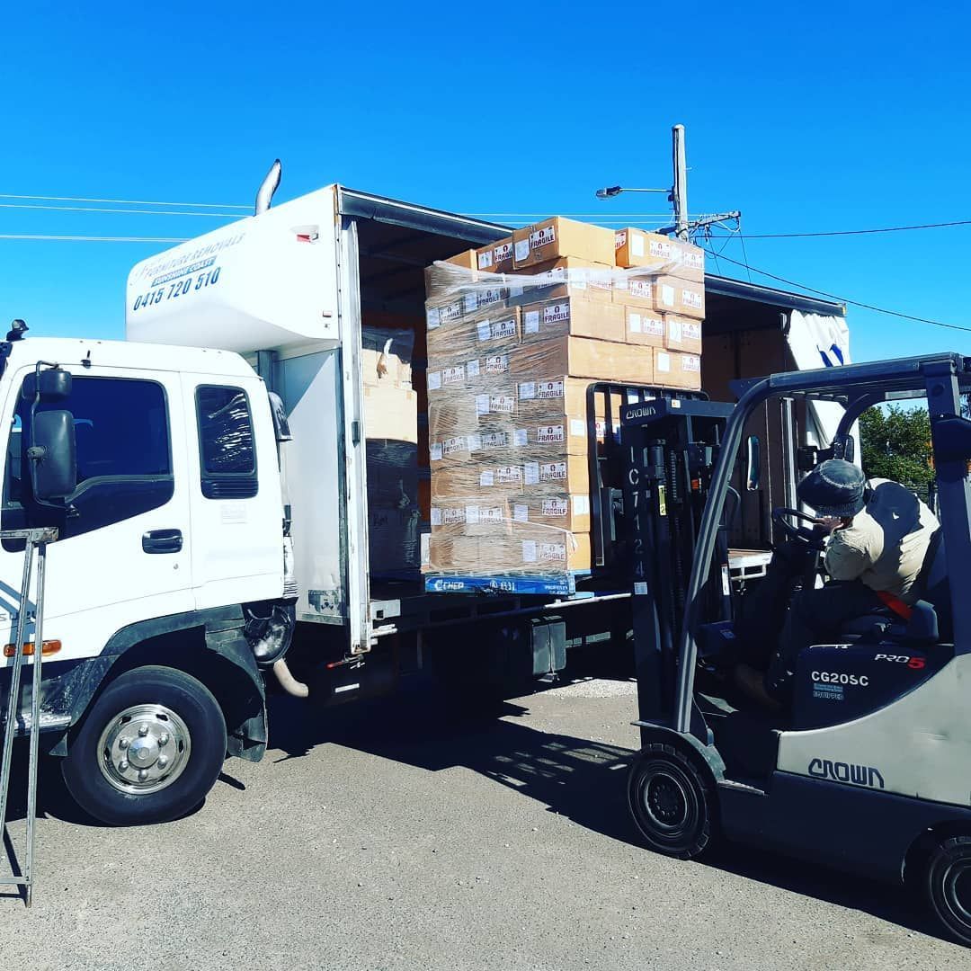 Forklift Loading Boxes From a Delivery Truck — John's Furniture Removals in Sunshine Coast, QLD