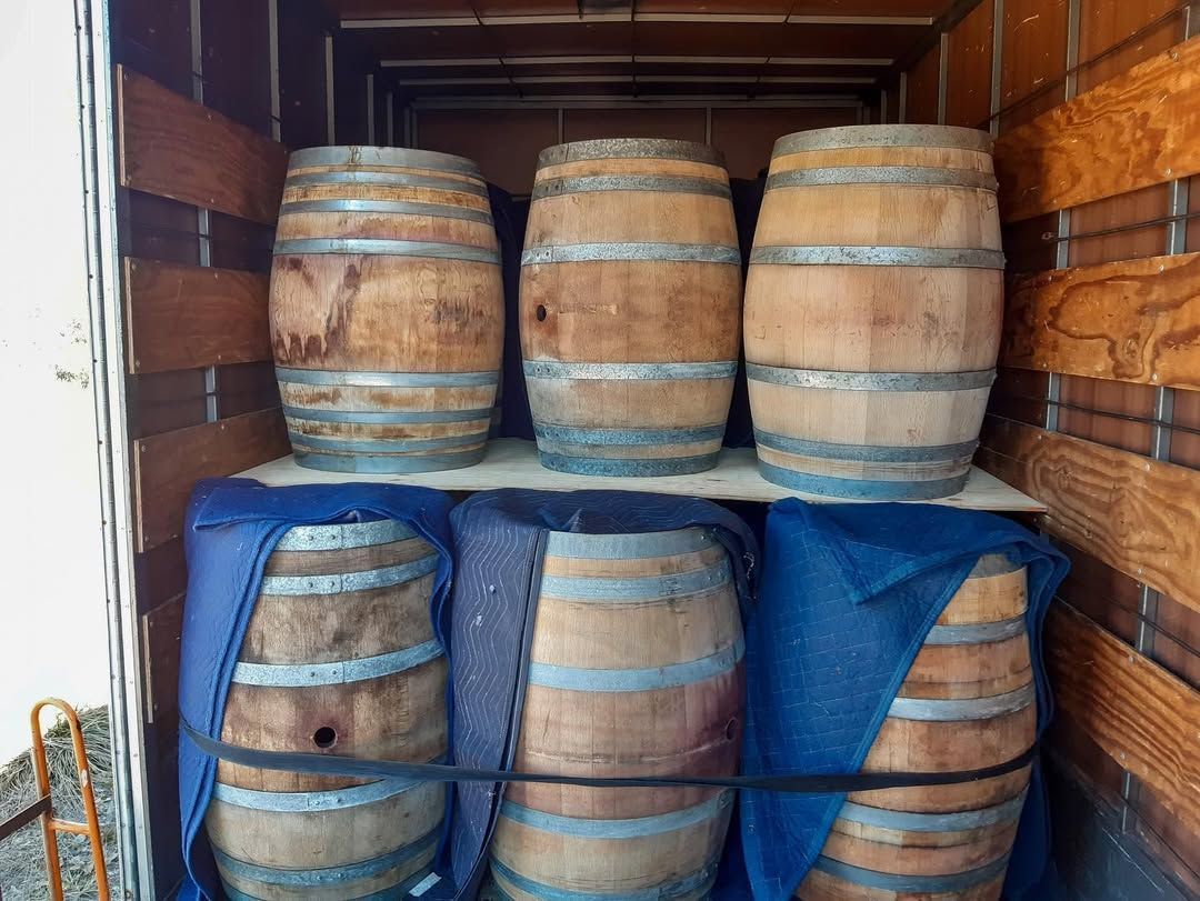 Six Wooden Barrels, Three Stacked Atop Three, Inside a Wooden Enclosure — John's Furniture Removals in Yandina, QLD
