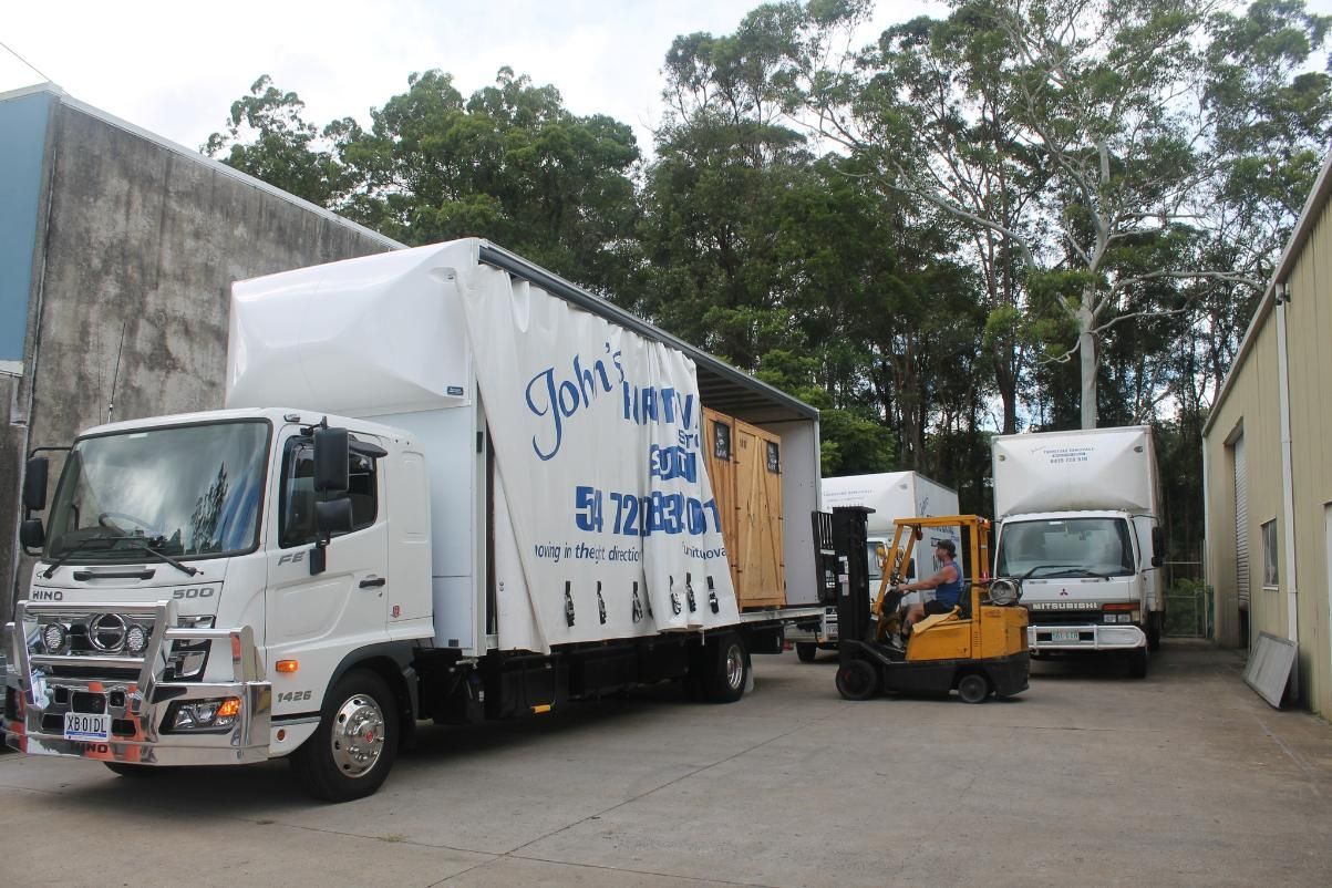 Truck Loading With a Forklift at a Building Site — John's Furniture Removals in Gladstone, QLD