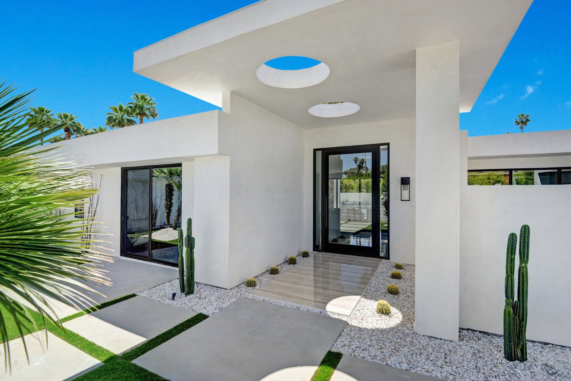 A white house with a blue sky in the background