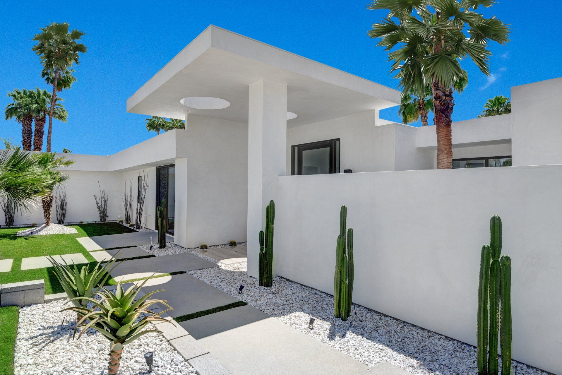 A white house with palm trees in front of it