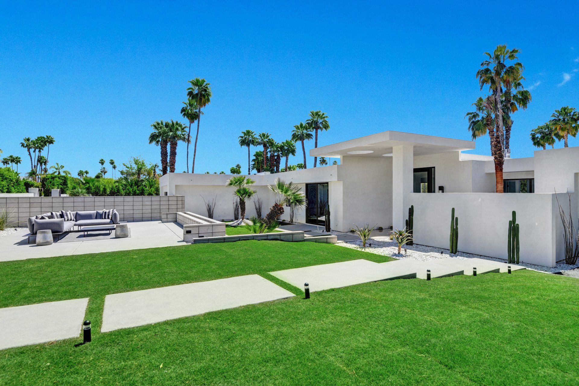 A white house with a large lawn in front of it
