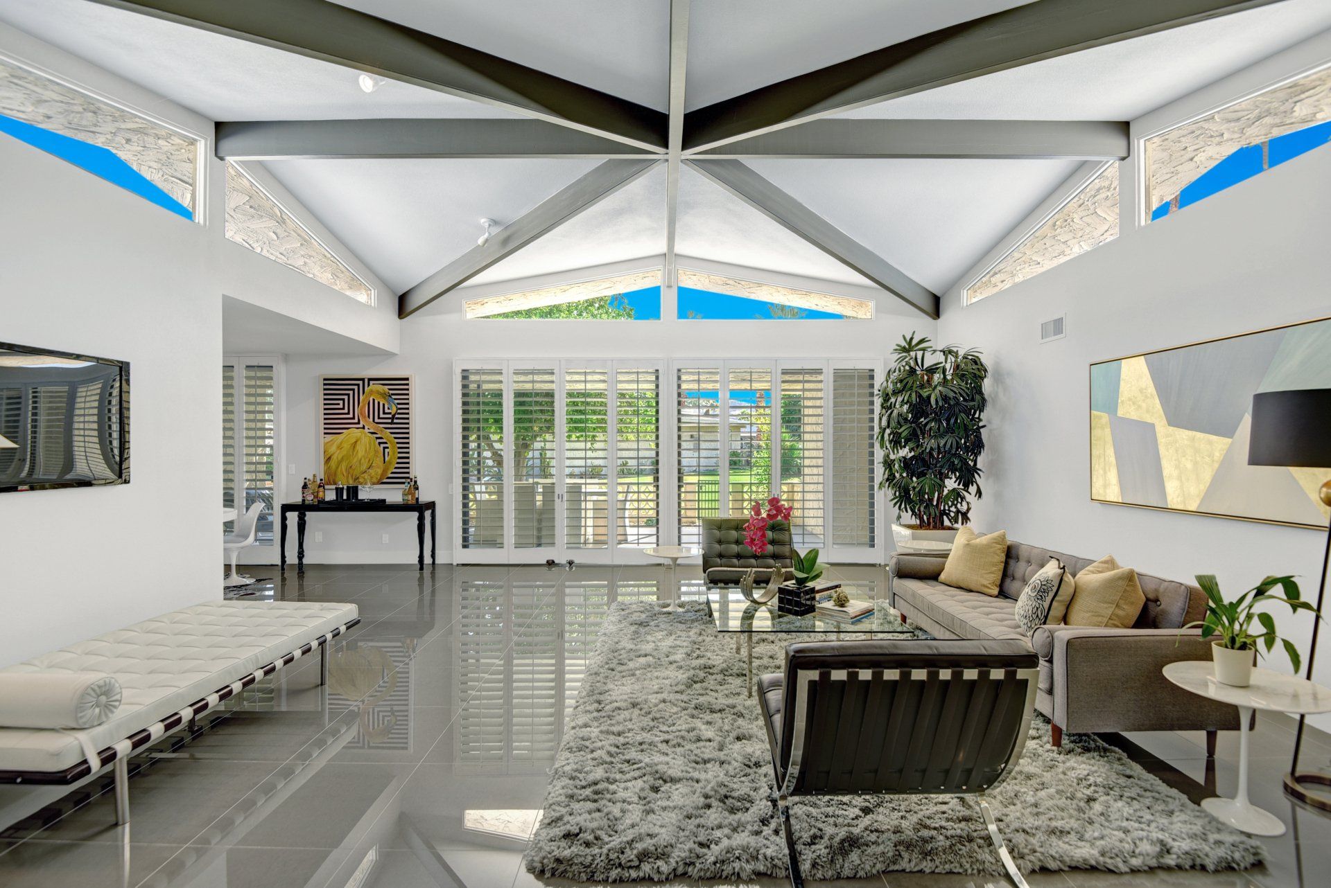 A living room with a couch , chairs , and a rug.