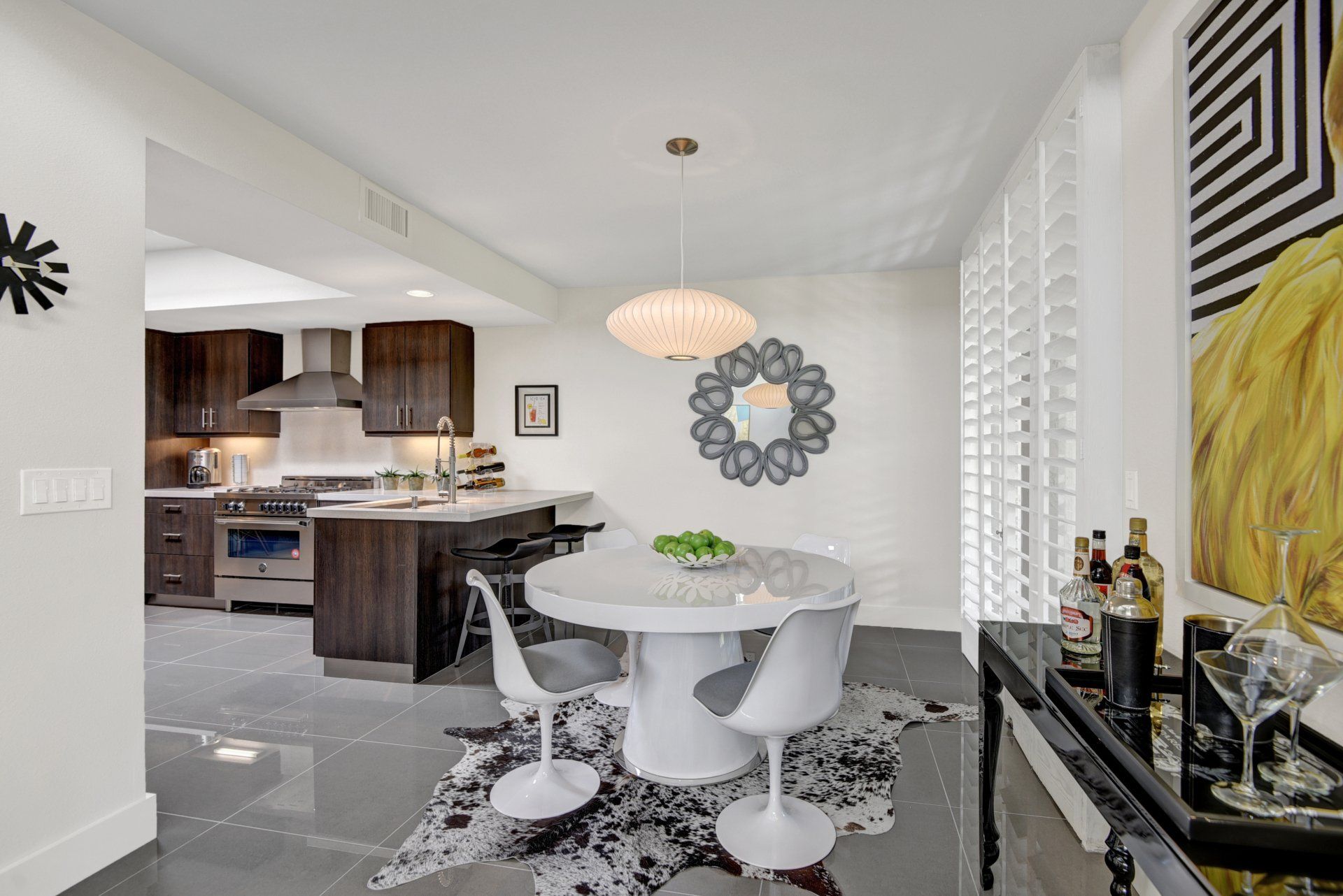 A dining room with a table and chairs and a bar.