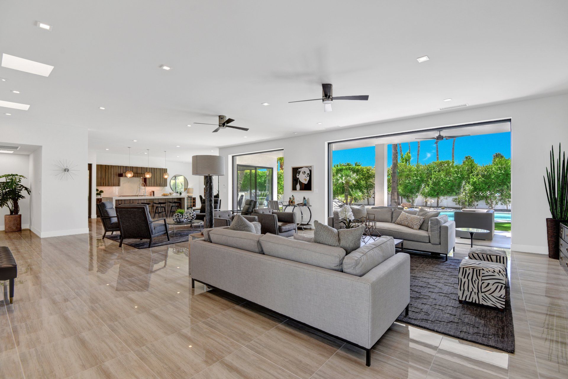 A living room filled with furniture and a ceiling fan.