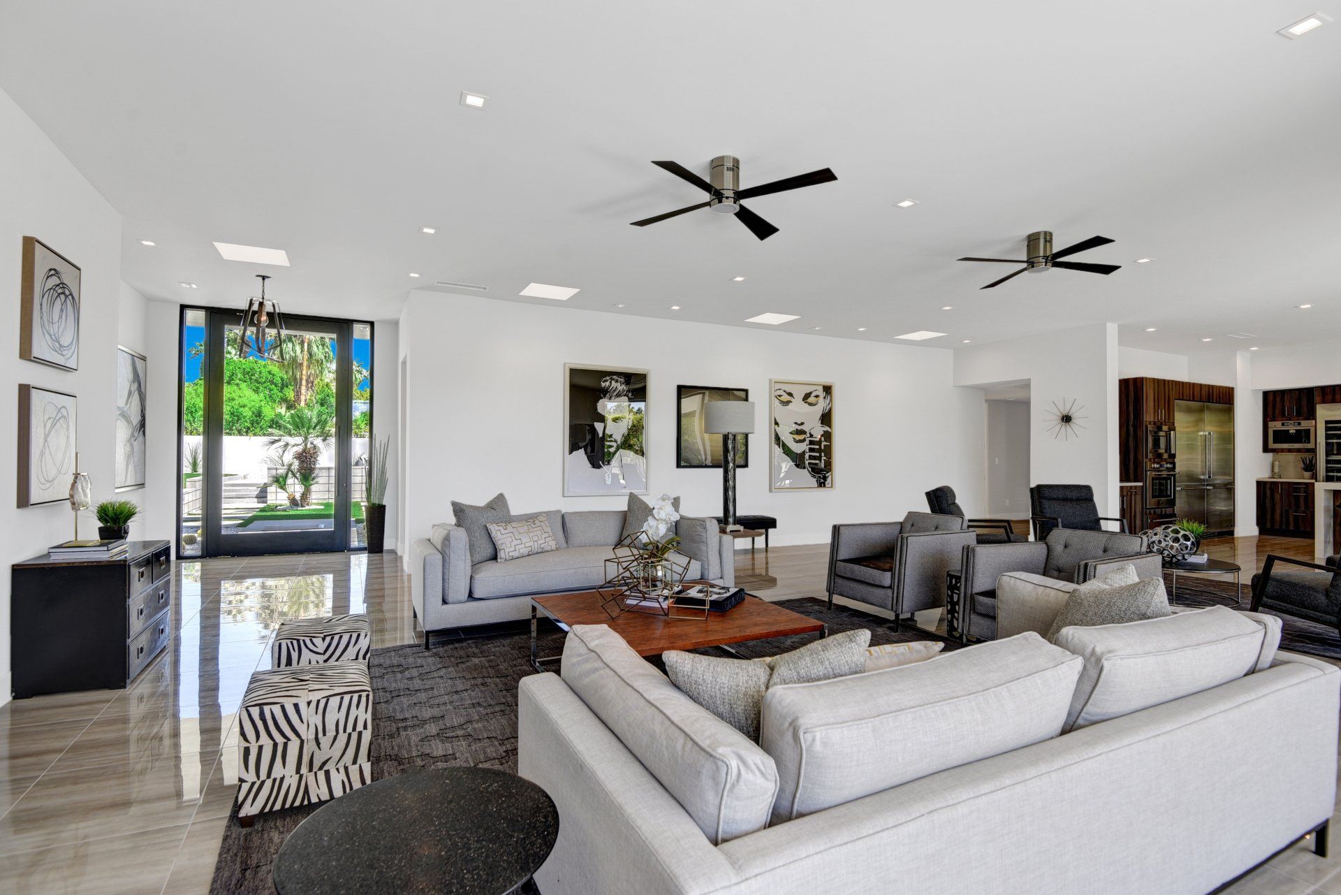 A living room filled with furniture and a ceiling fan.