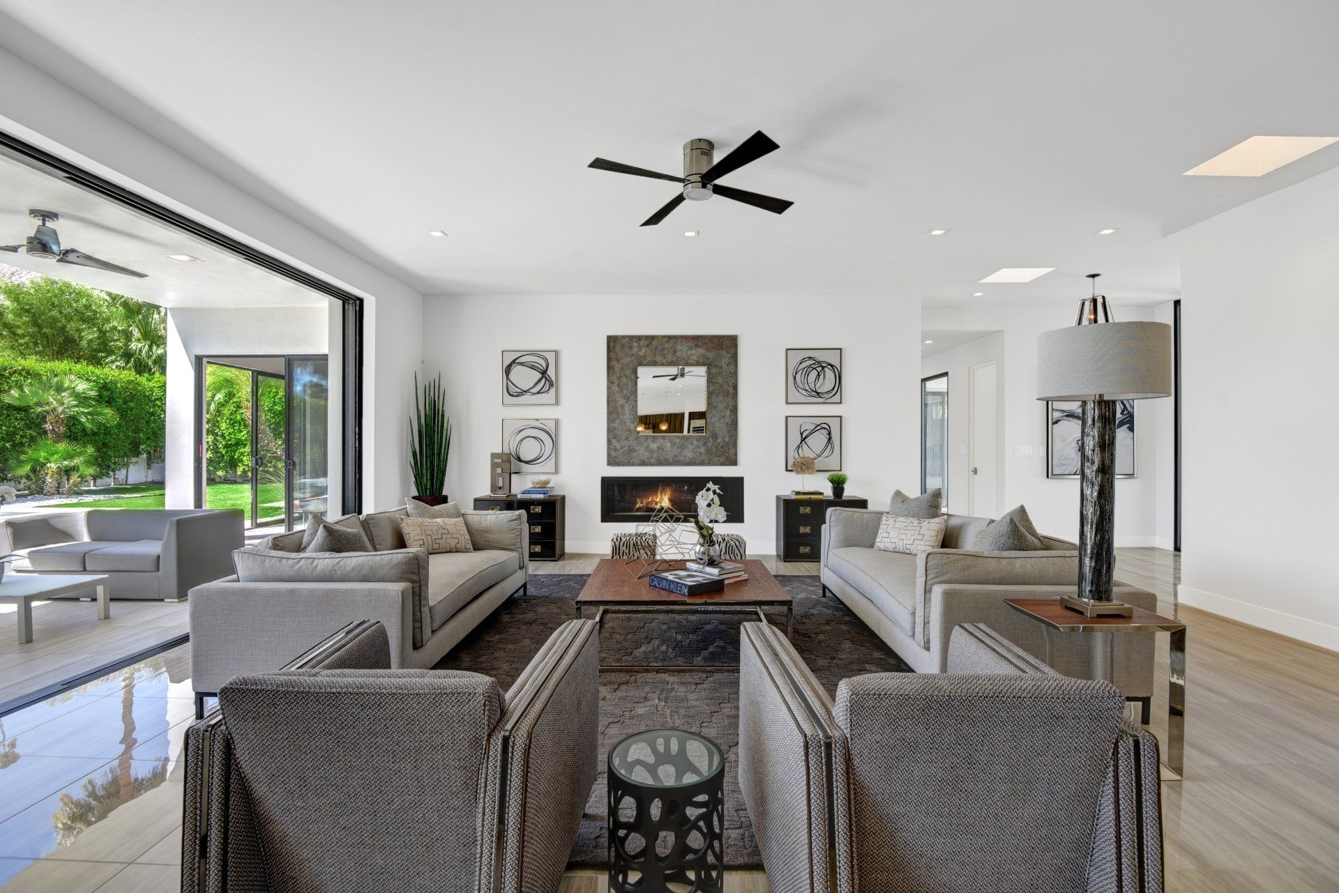 A living room filled with furniture and a ceiling fan.