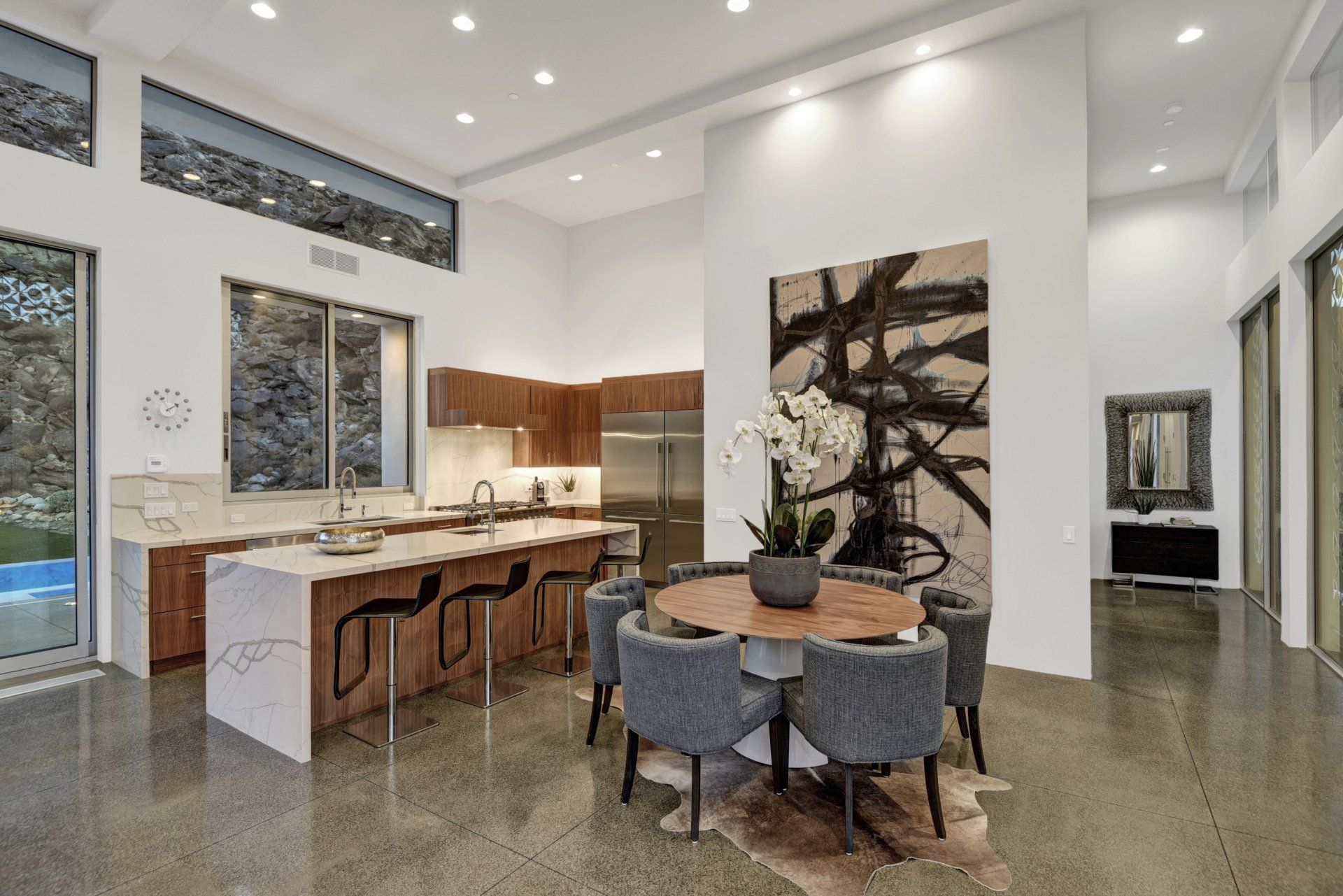 A kitchen and dining room in a house with a table and chairs.
