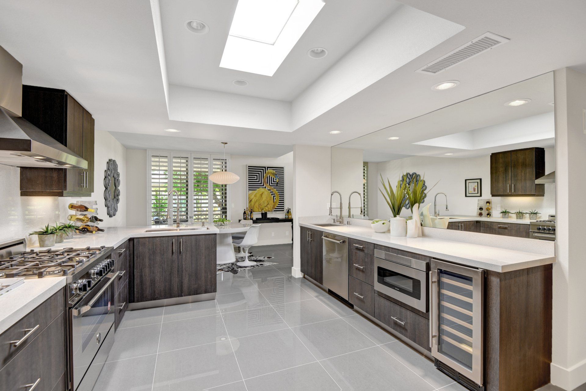 A large kitchen with stainless steel appliances and wooden cabinets