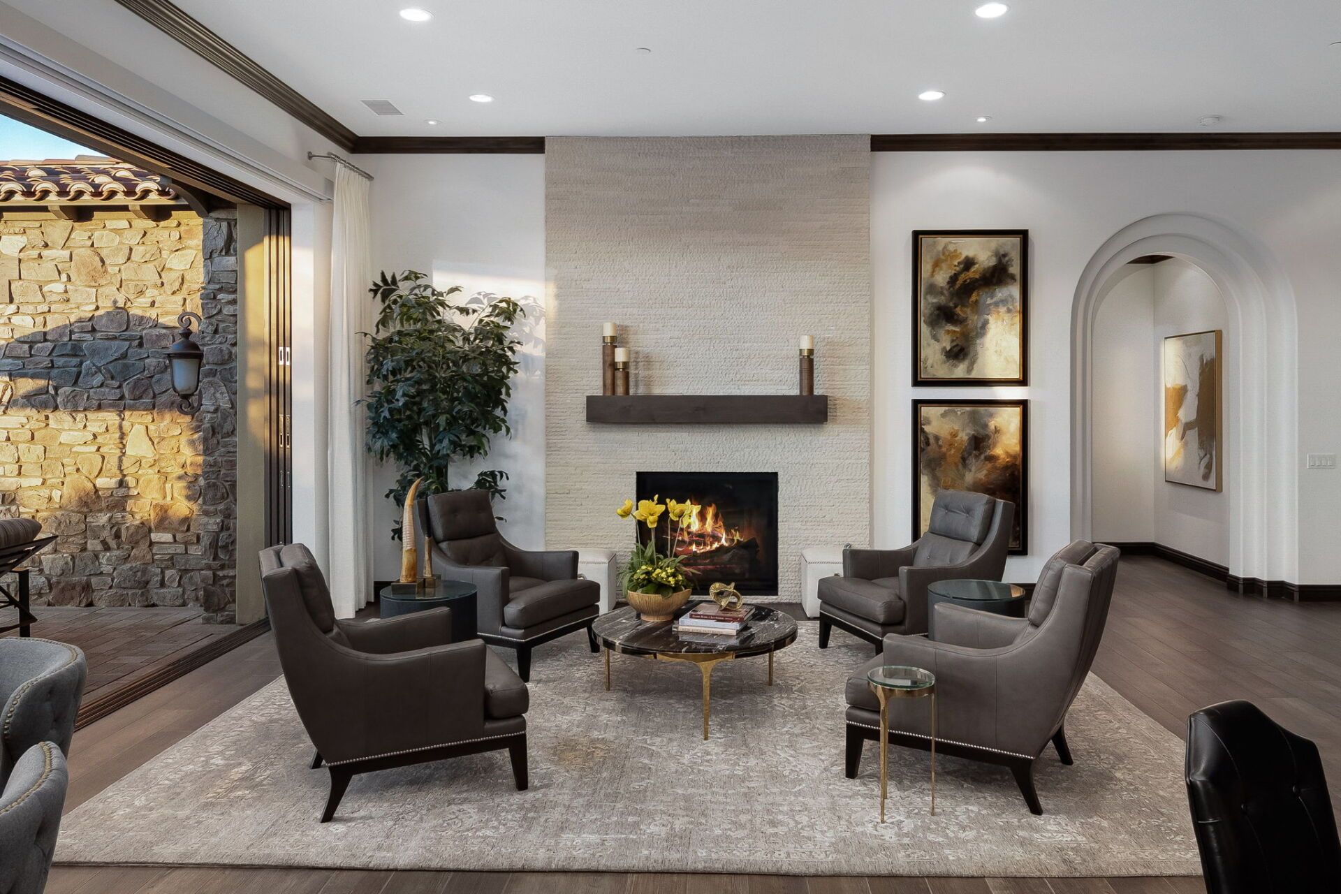 A living room with a fireplace and chairs