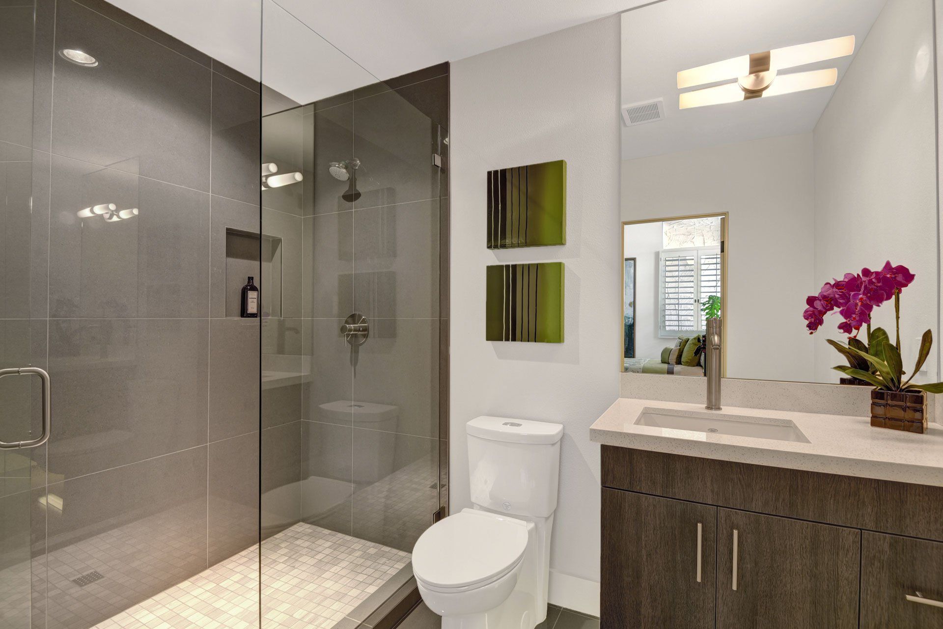 A bathroom with a toilet , sink , and walk in shower.