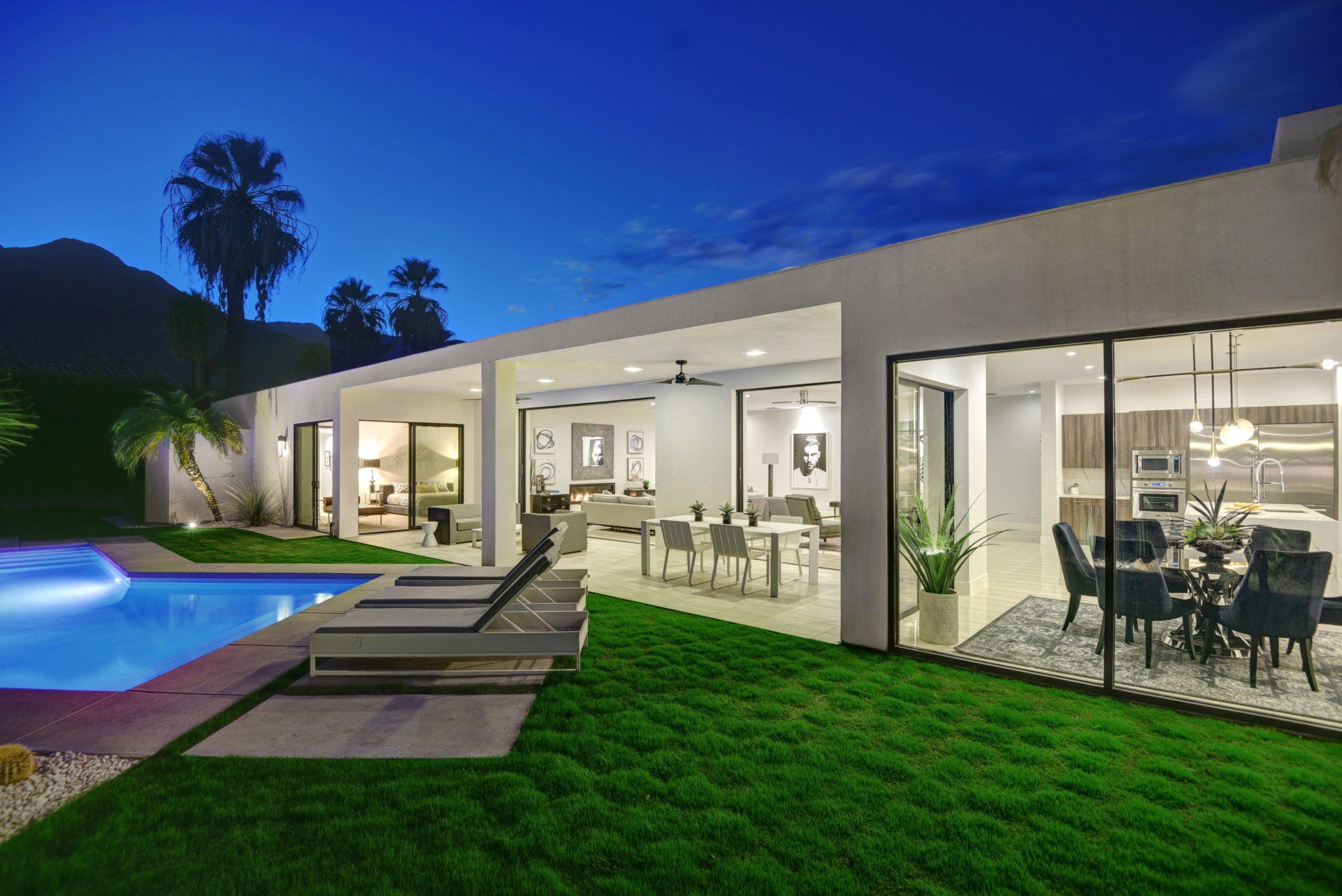 A modern house with a large swimming pool and a dining room.