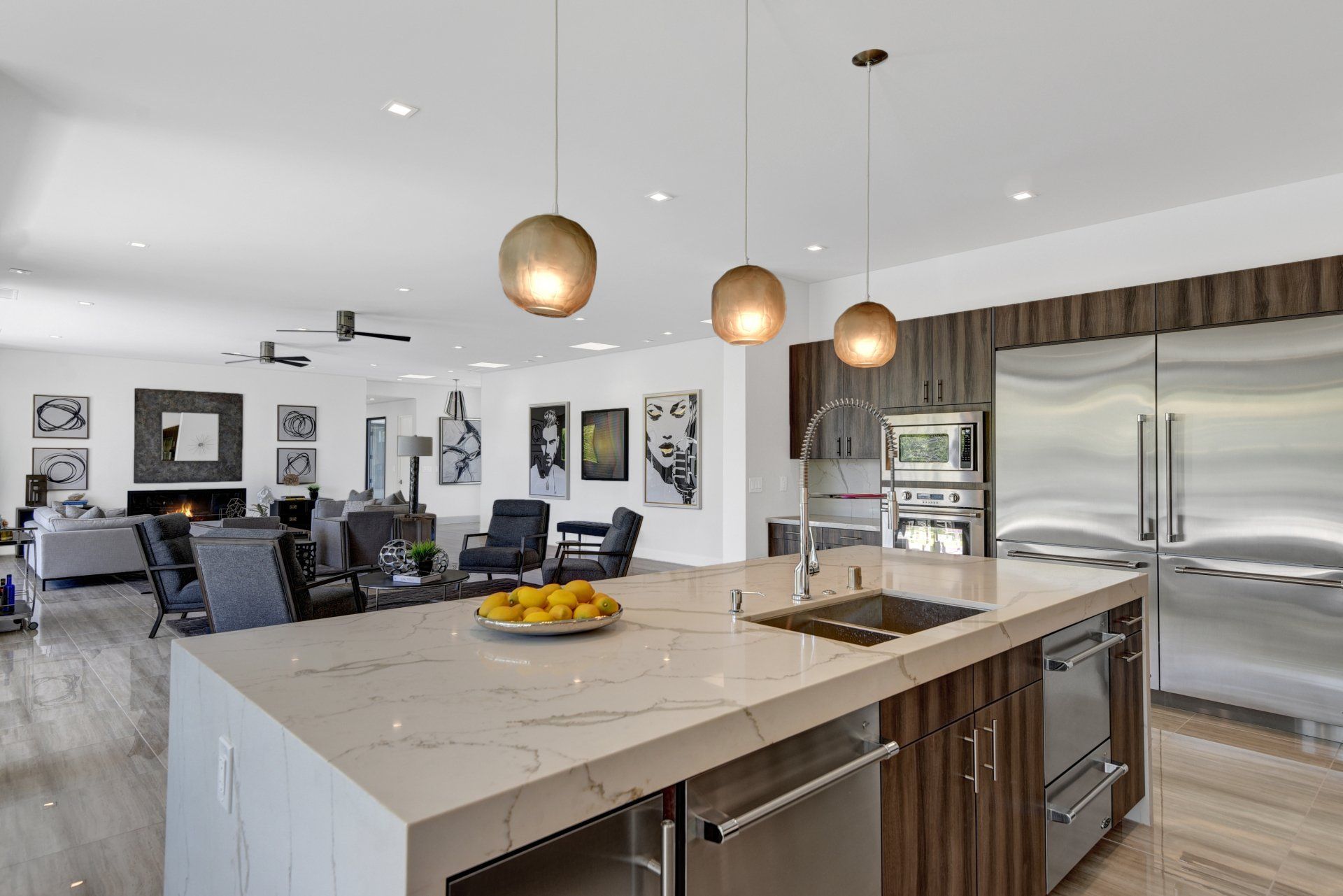 A kitchen with a large island and stainless steel appliances.