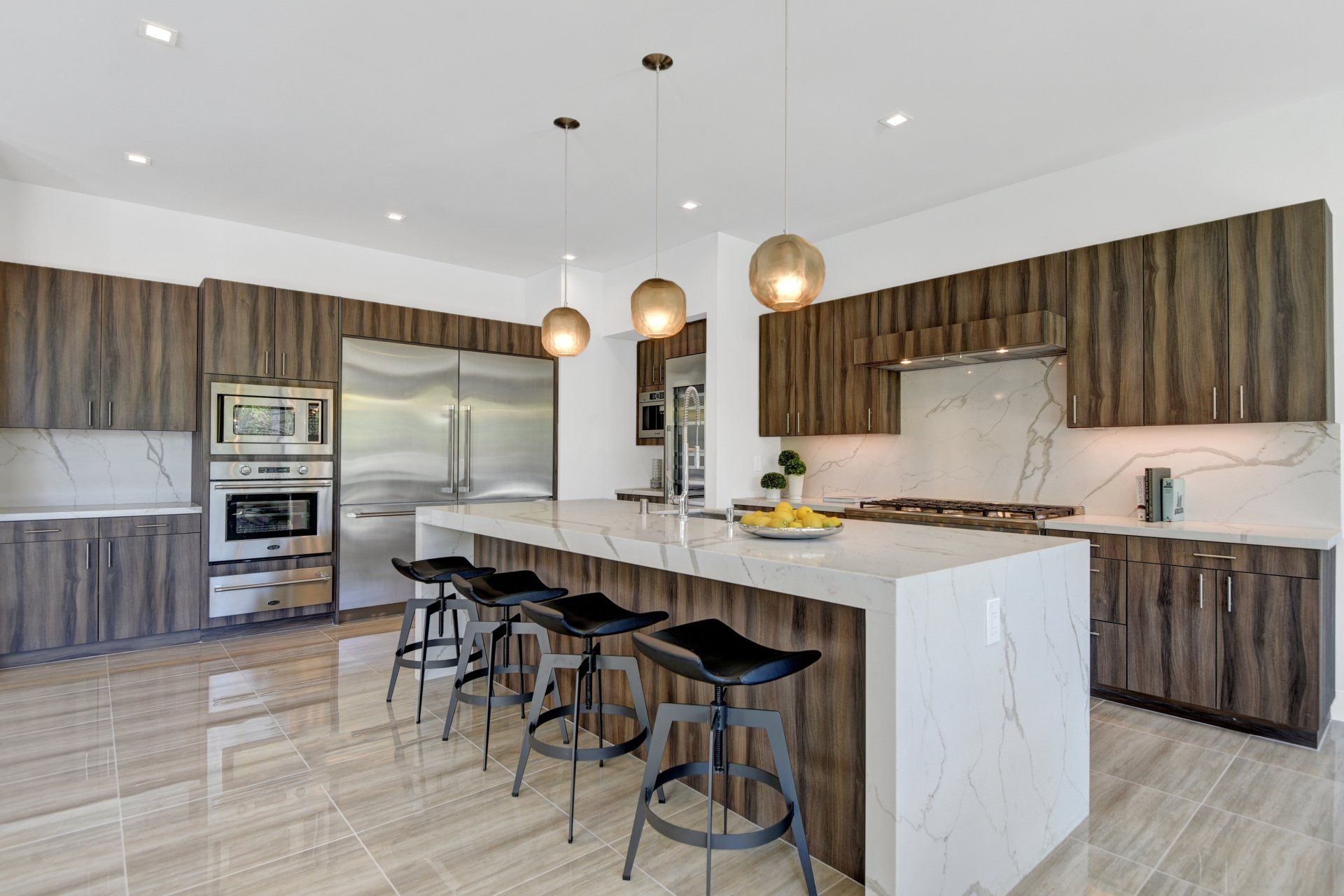 A large kitchen with a large island and stools.