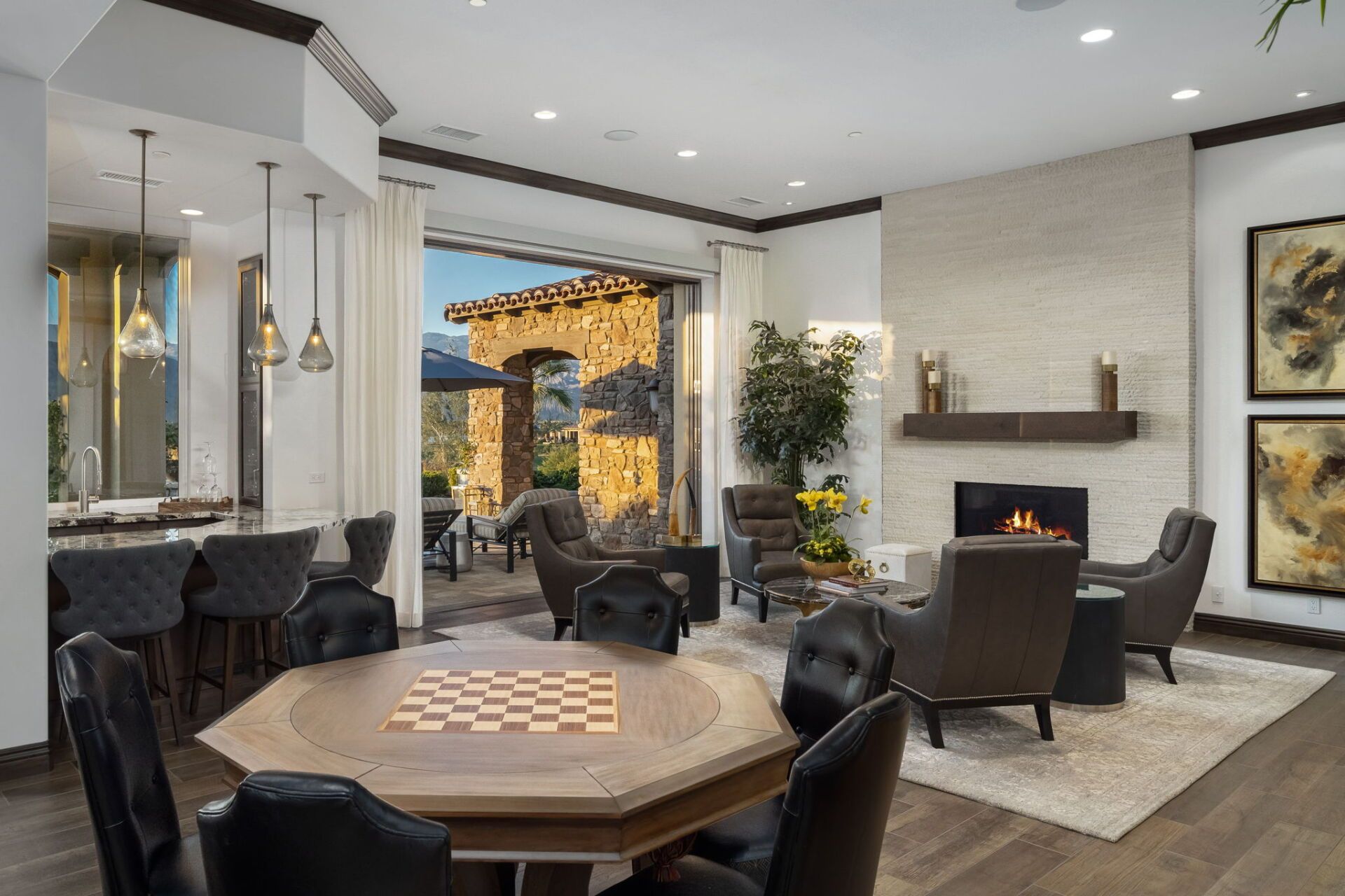A living room with a table and chairs and a fireplace.