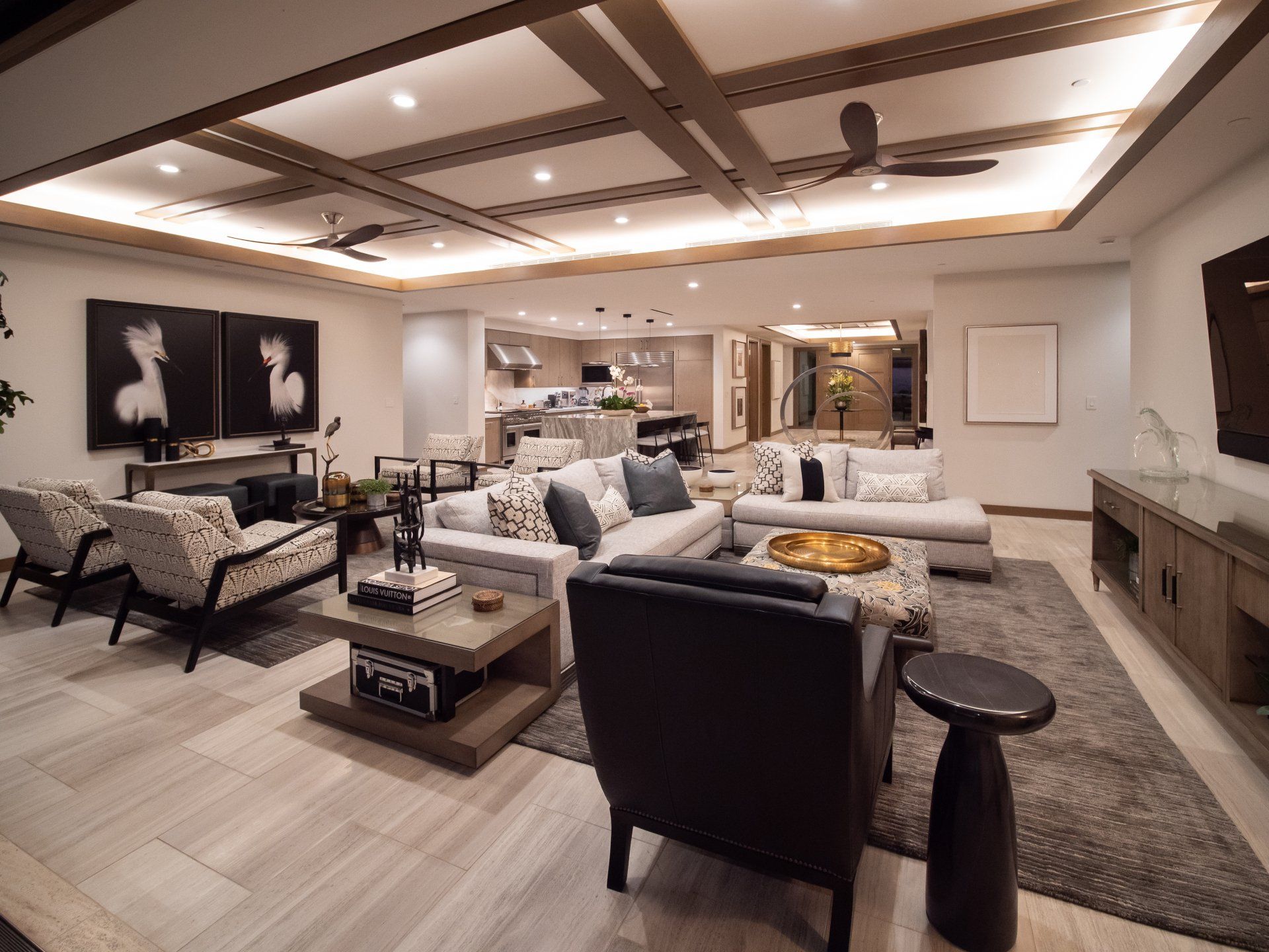 A living room with a lot of furniture and a ceiling fan