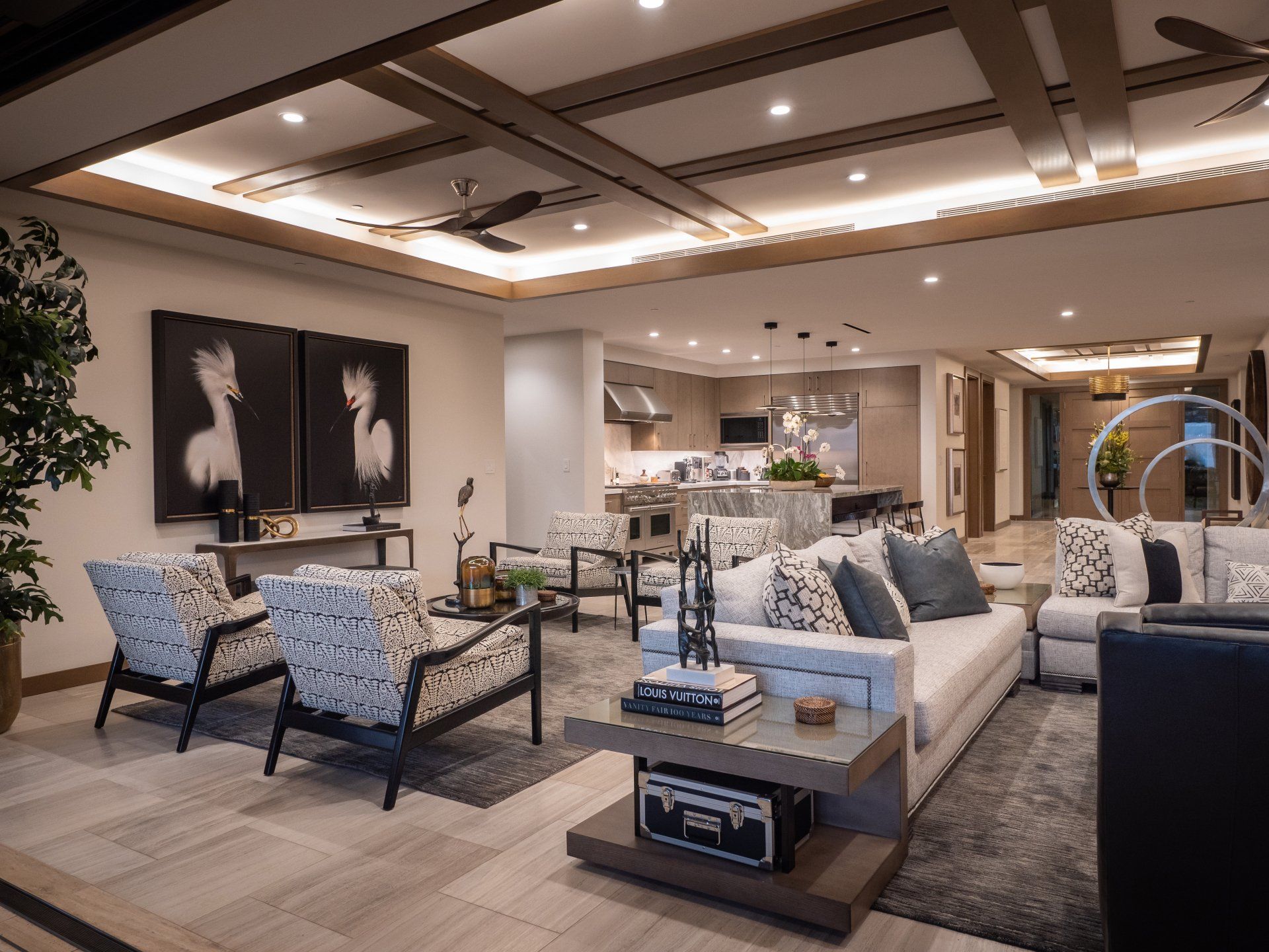A living room with a couch , chairs , and a coffee table.