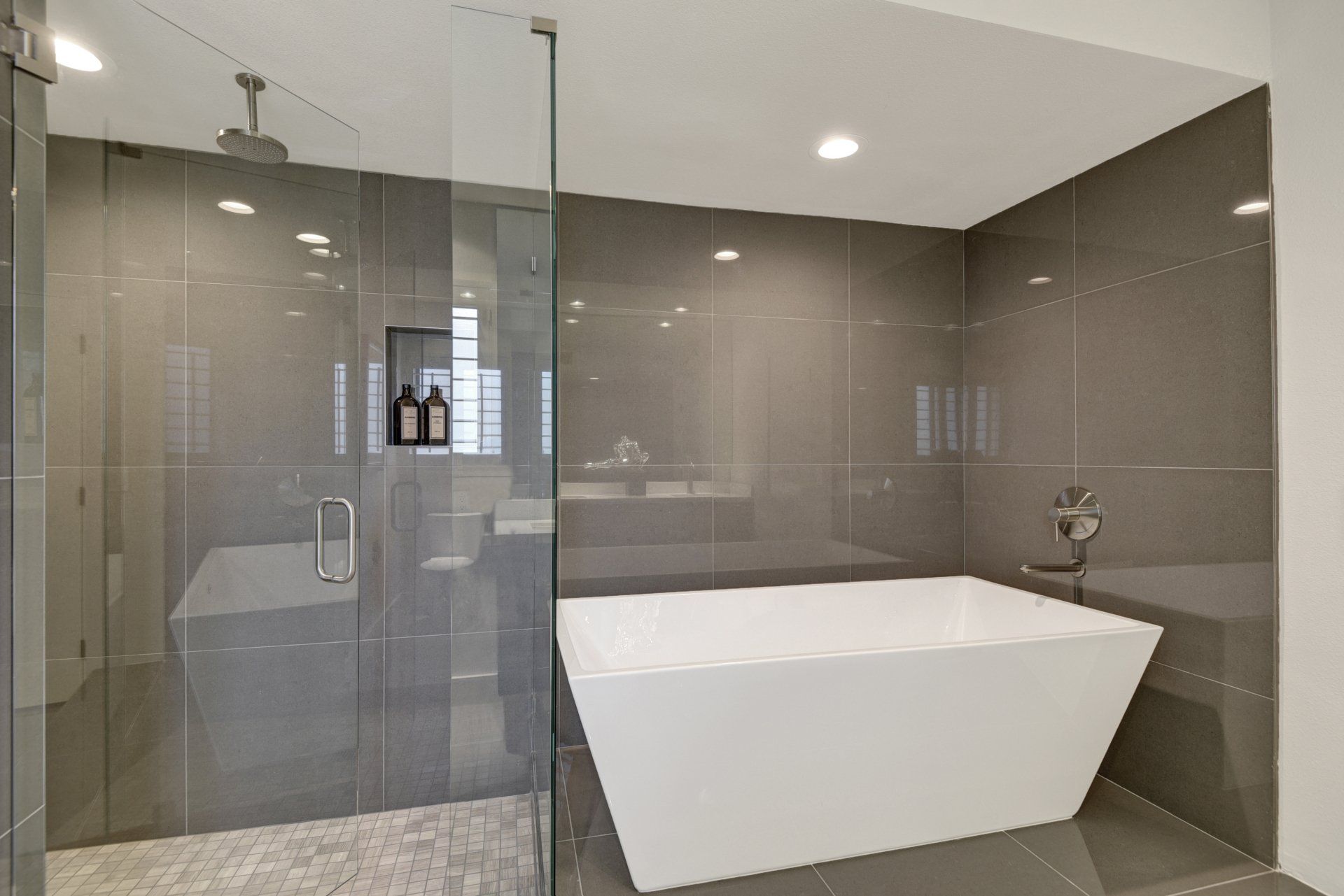 A bathroom with a bathtub and a walk in shower.