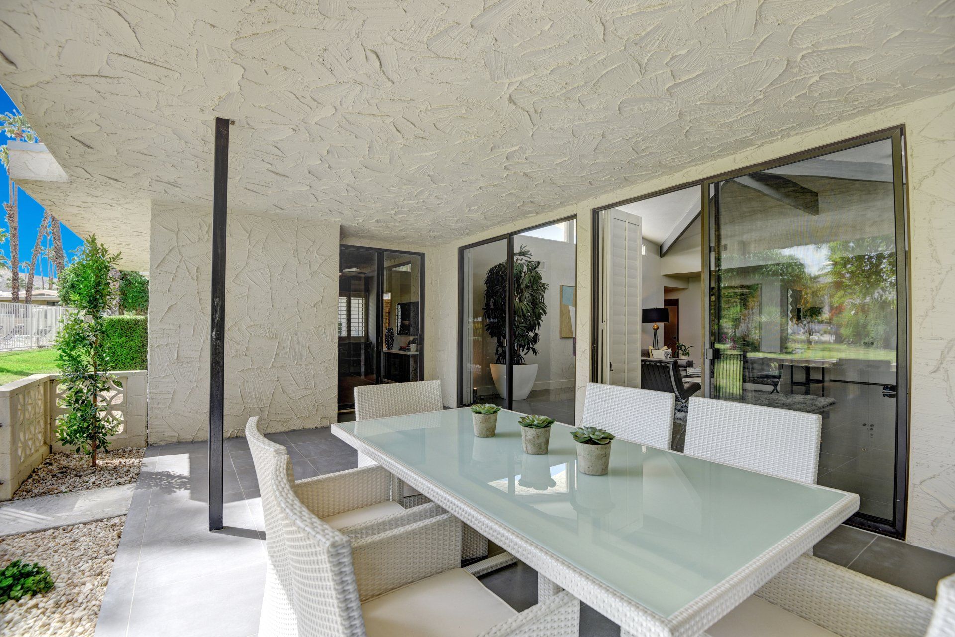 There is a table and chairs on the patio of a house.