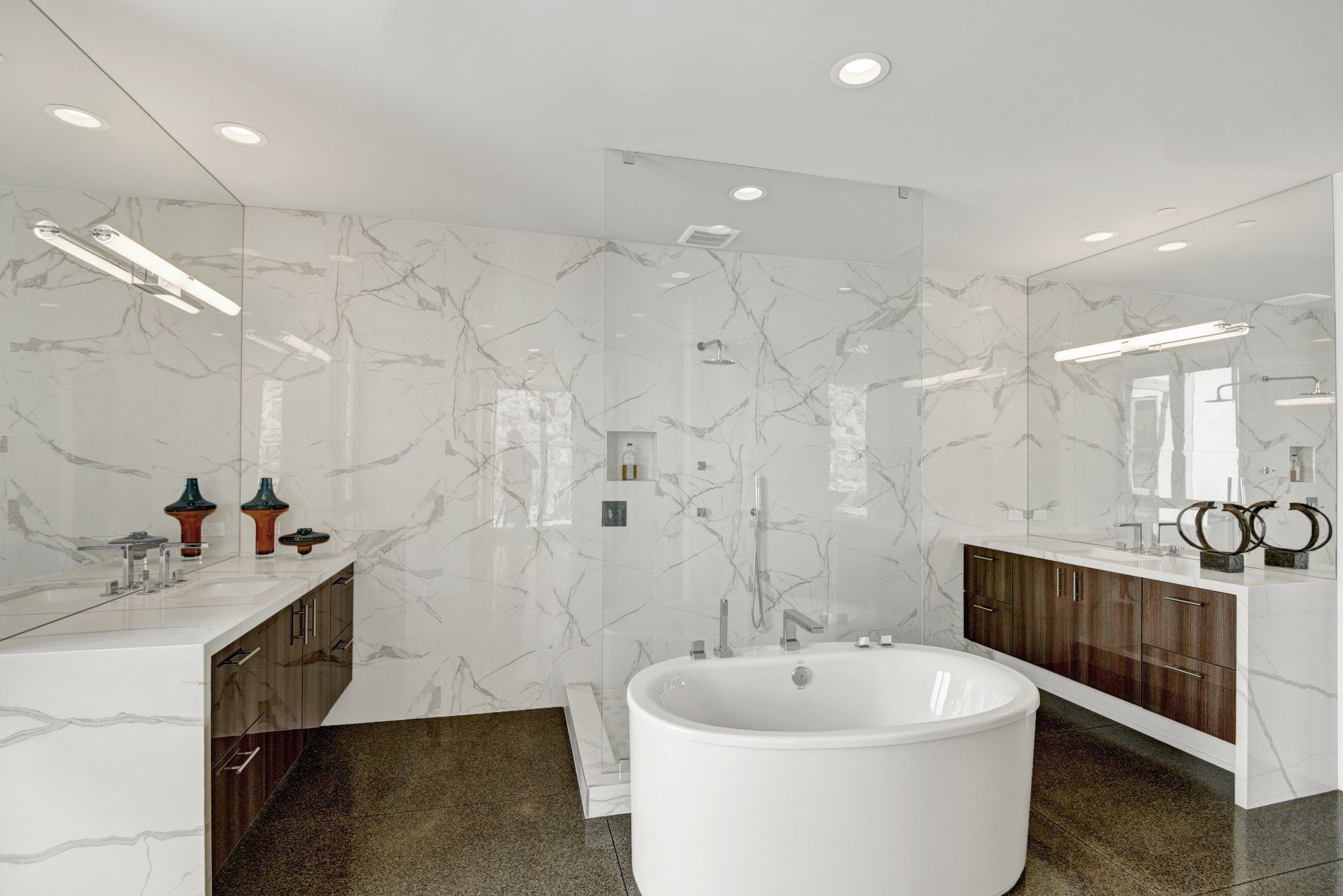 A bathroom with a tub , sink , mirror and walk in shower.