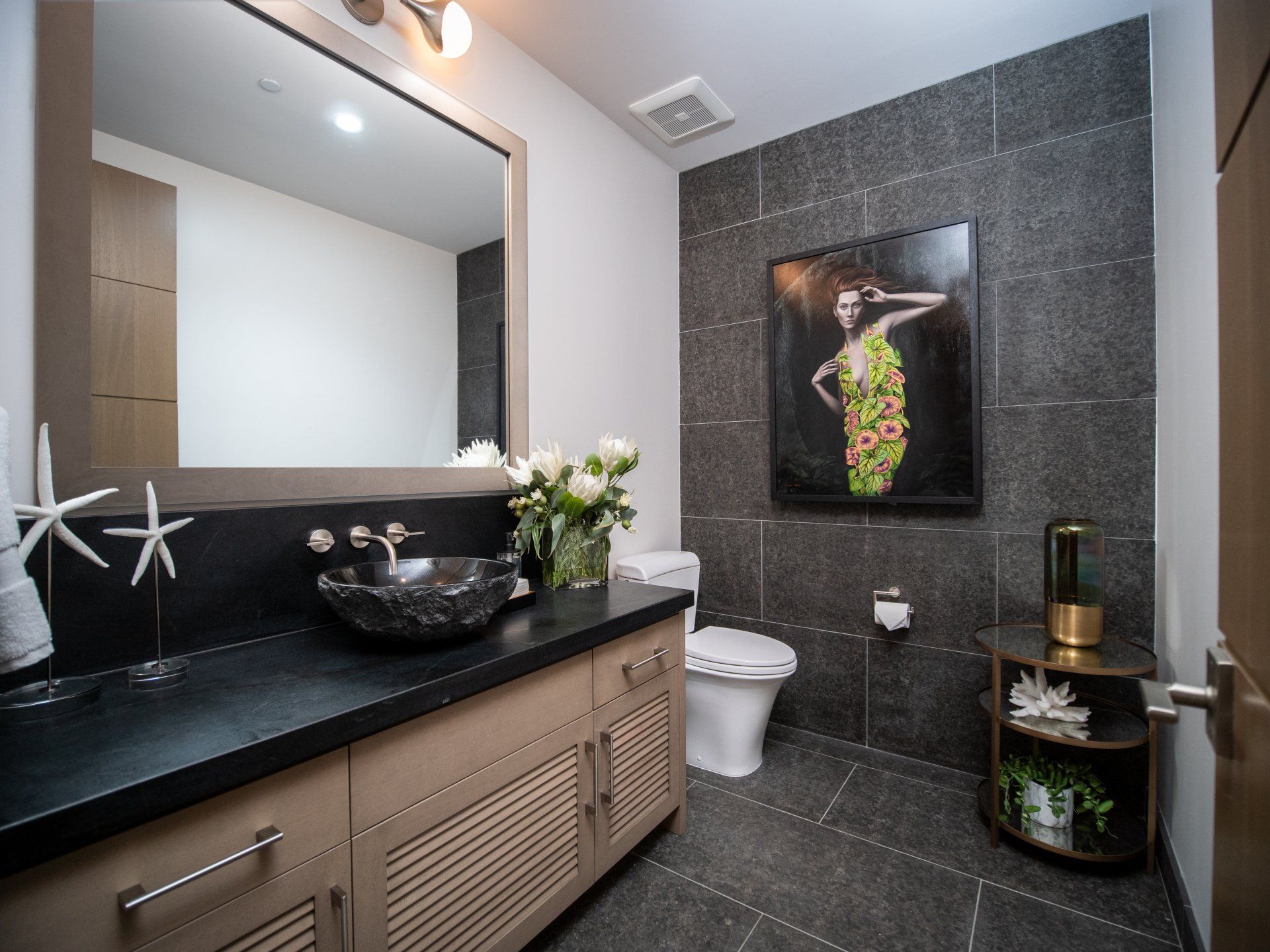 A bathroom with a sink , toilet and mirror