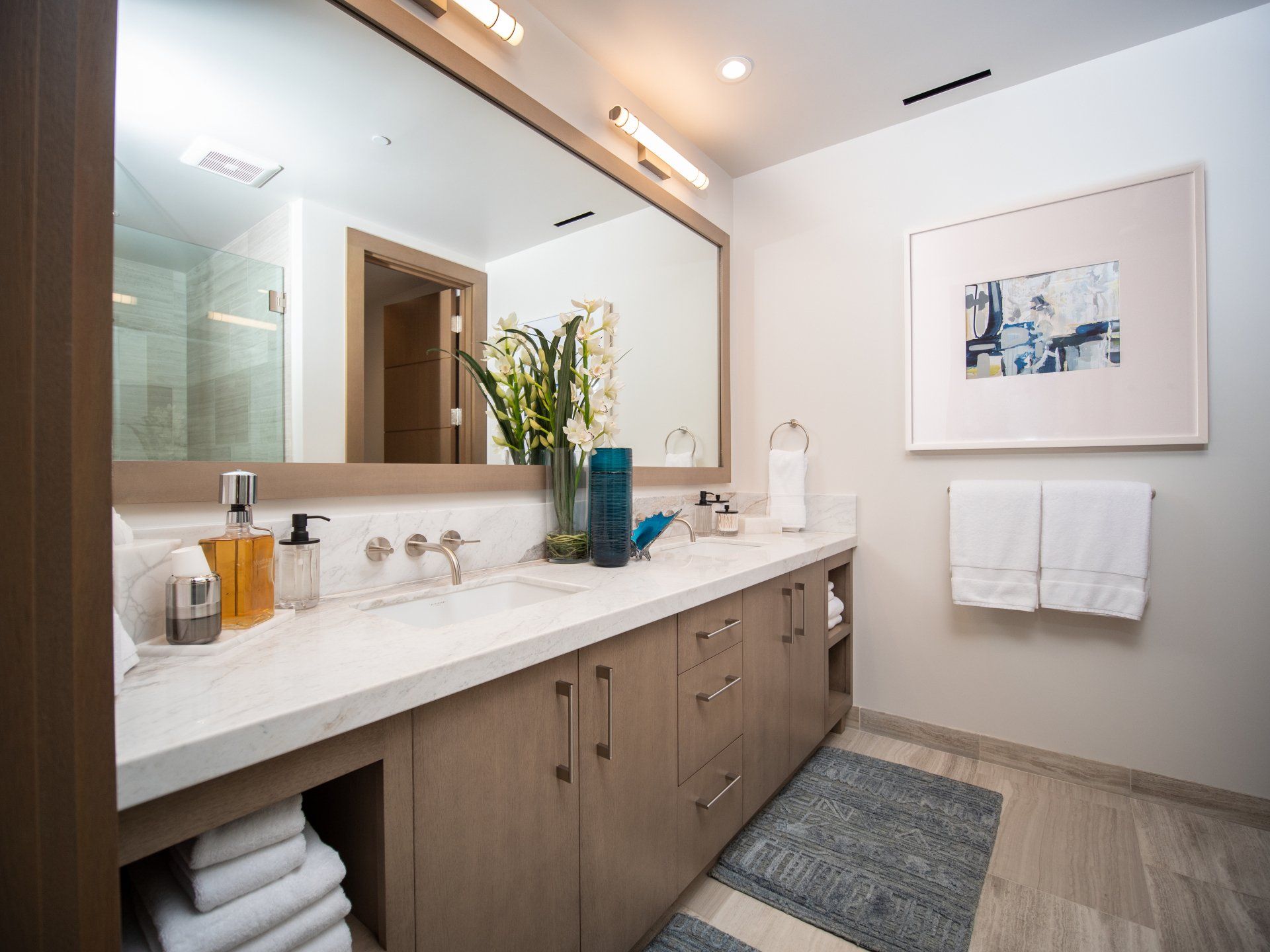 A bathroom with two sinks and a large mirror.