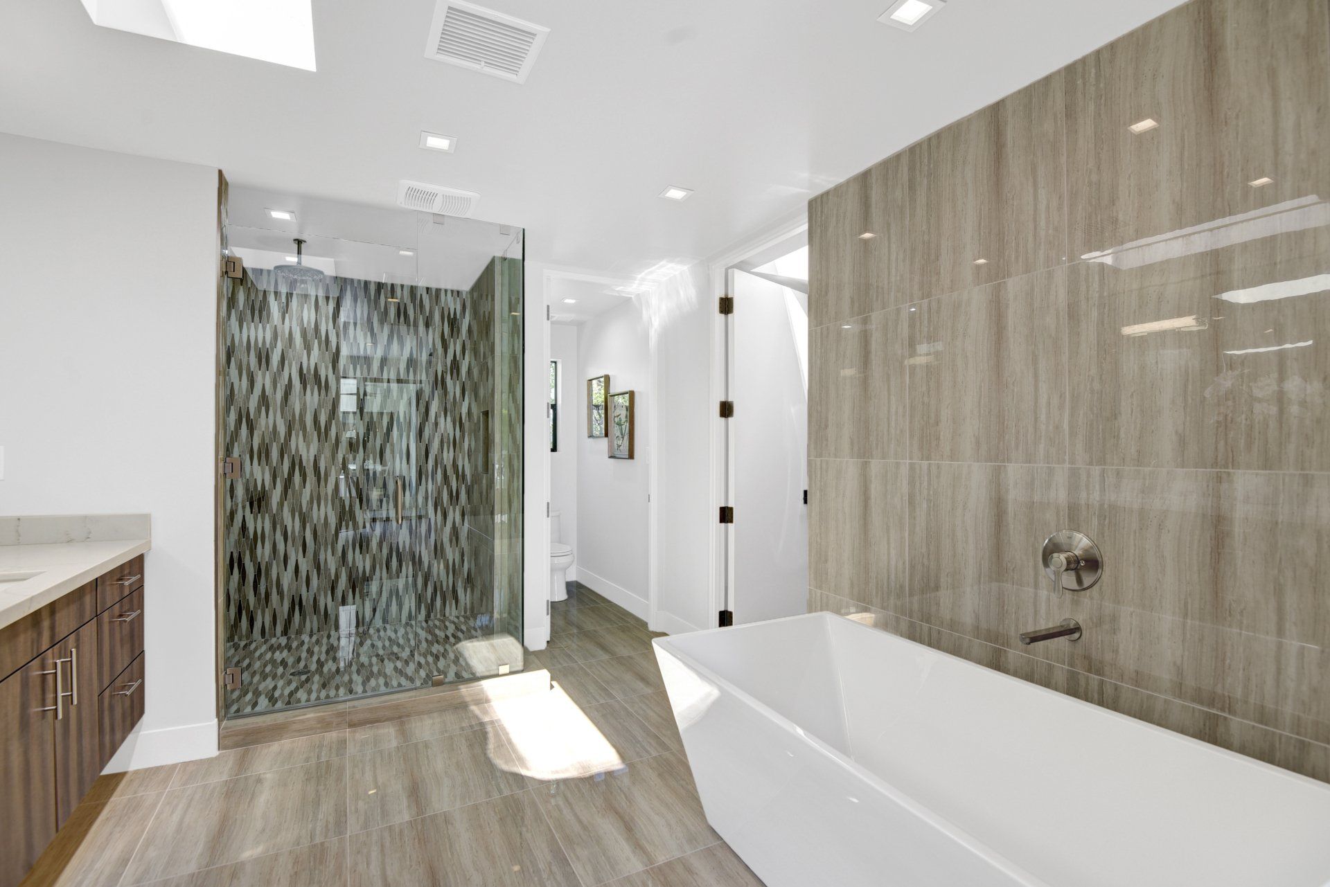 A bathroom with a bathtub and a walk in shower.
