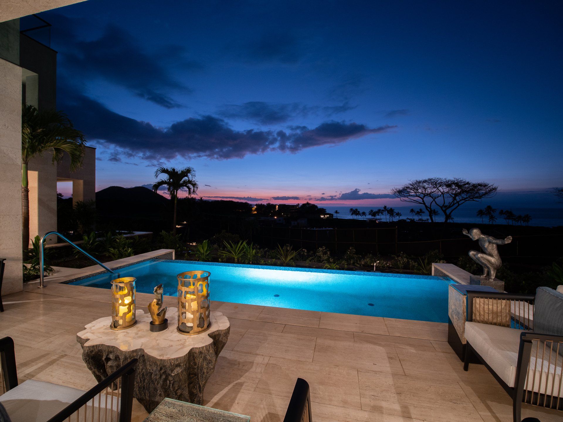 A large swimming pool is lit up at night.