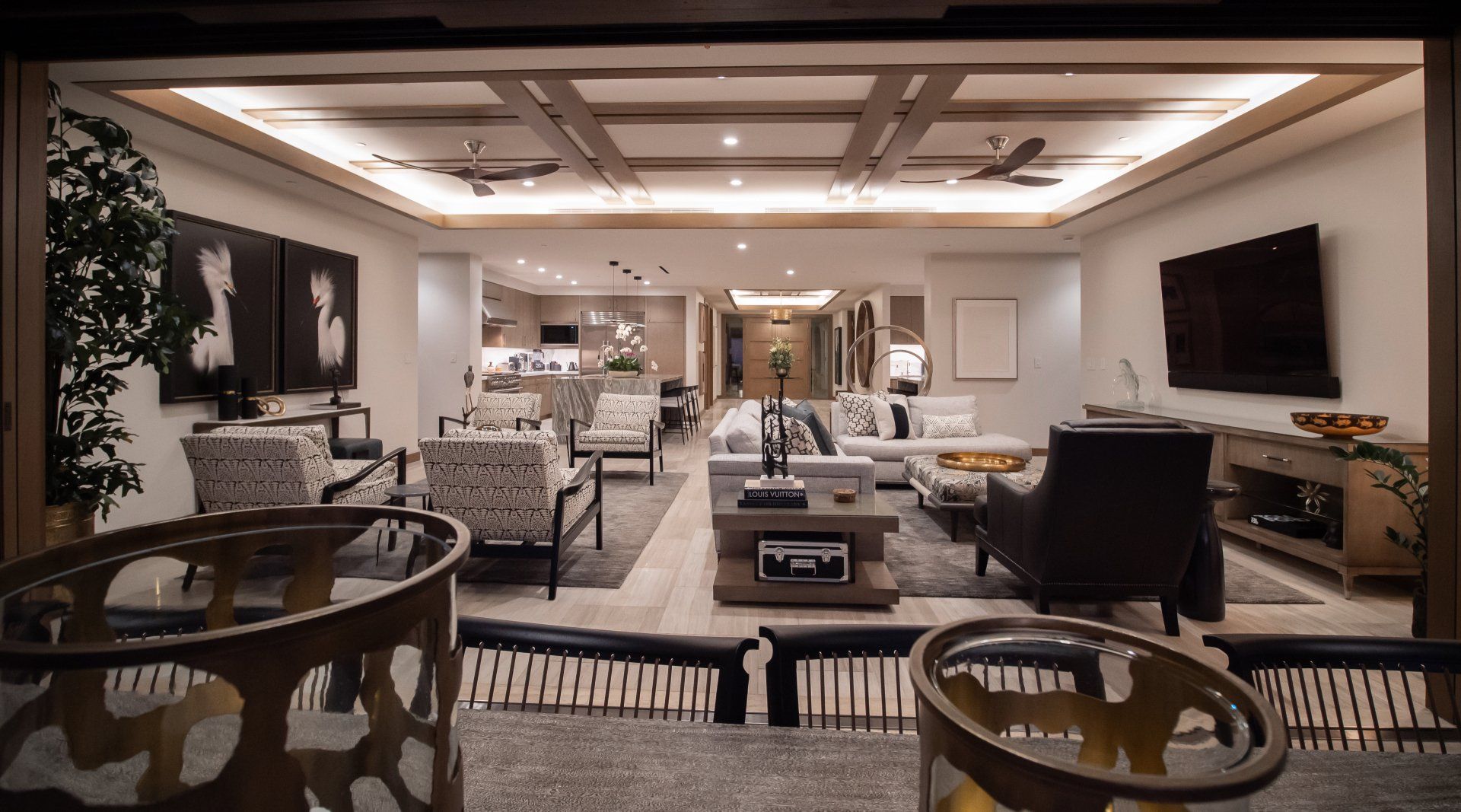 A living room with a lot of furniture and a flat screen tv.