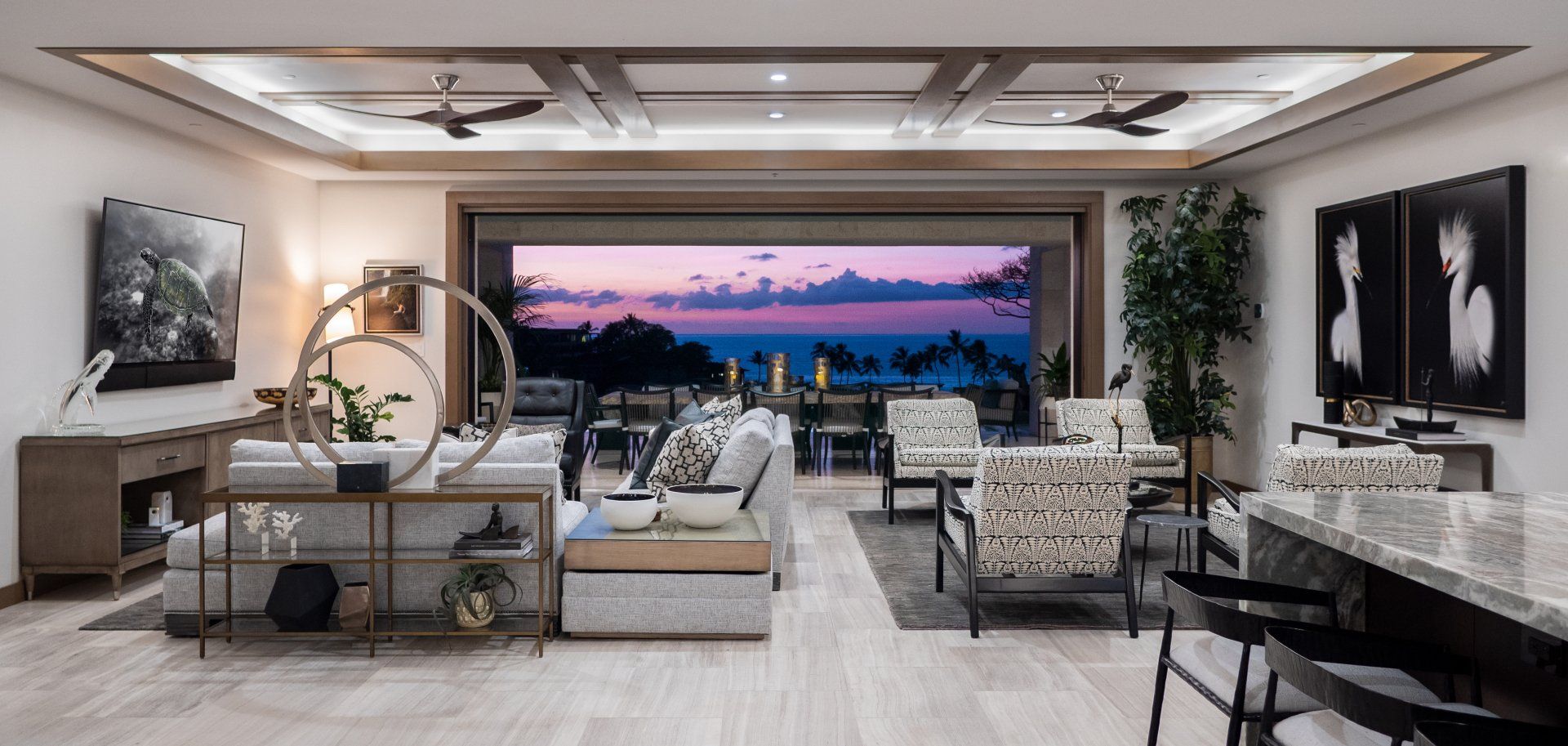 A living room with a large window and a view of the ocean.