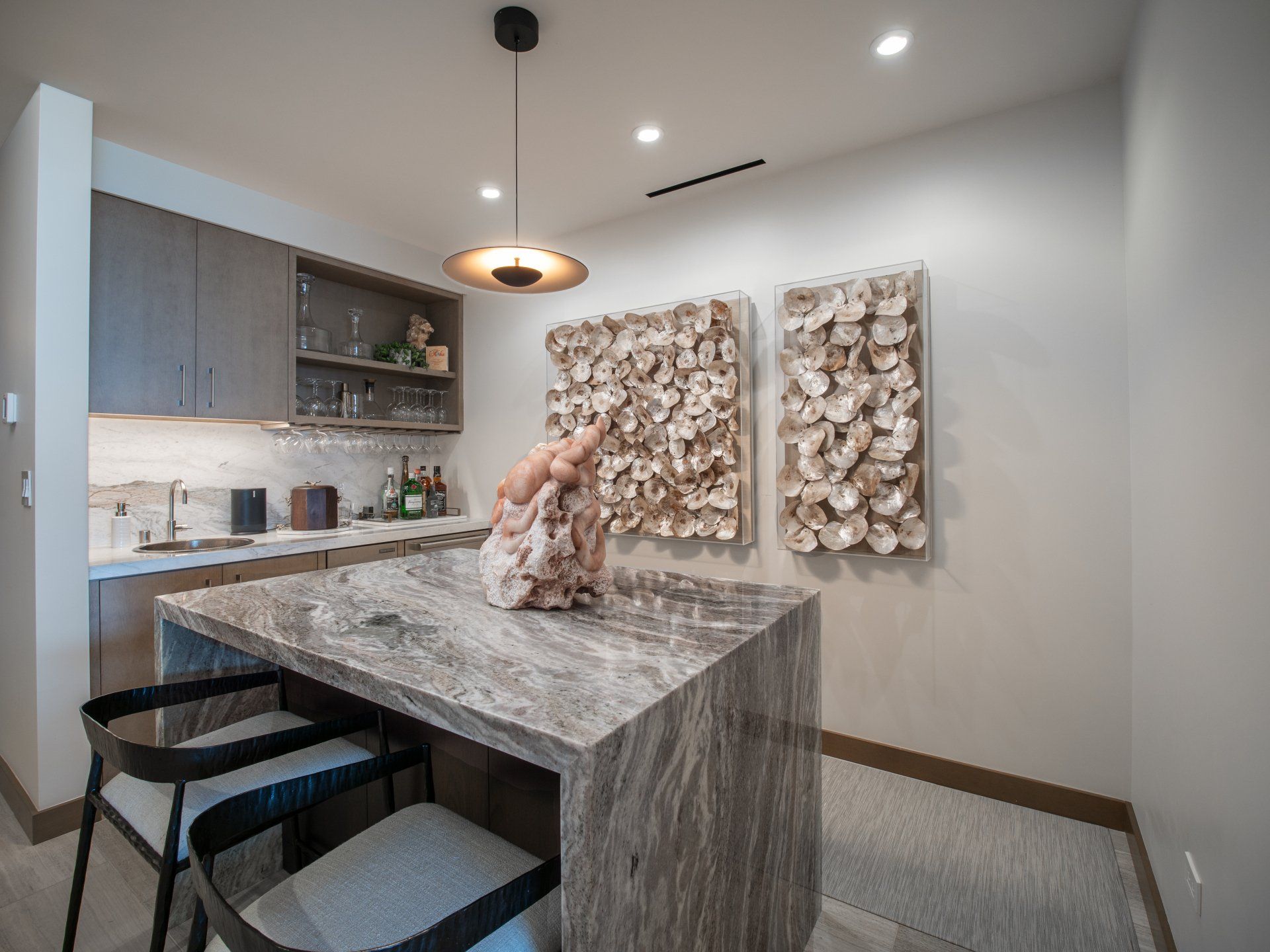 A kitchen with a table and chairs and a bar.
