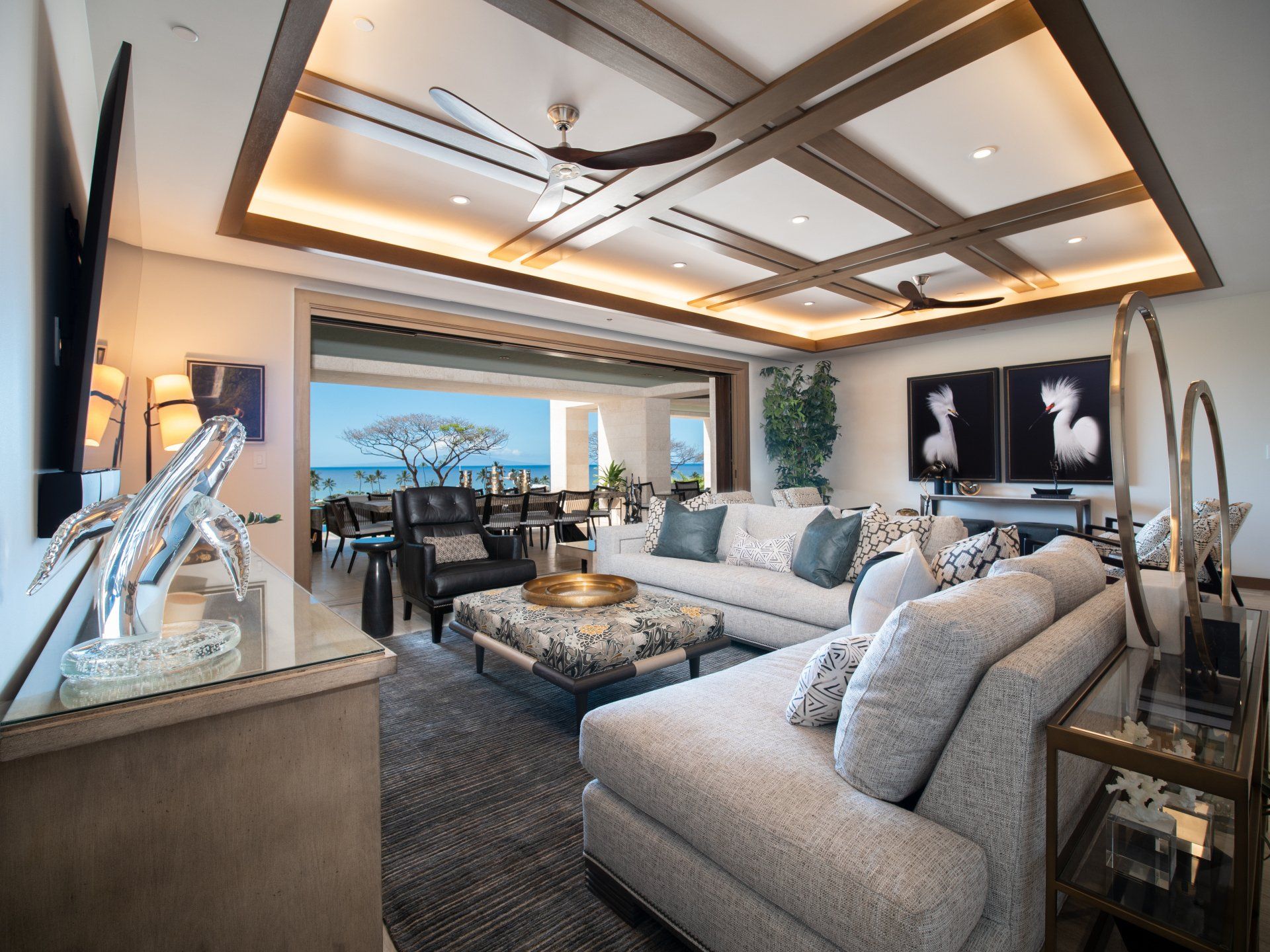 A living room with a large sectional couch and a flat screen tv