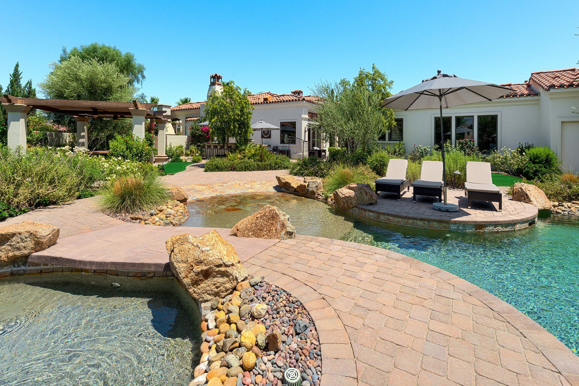 A large swimming pool in the backyard of a house