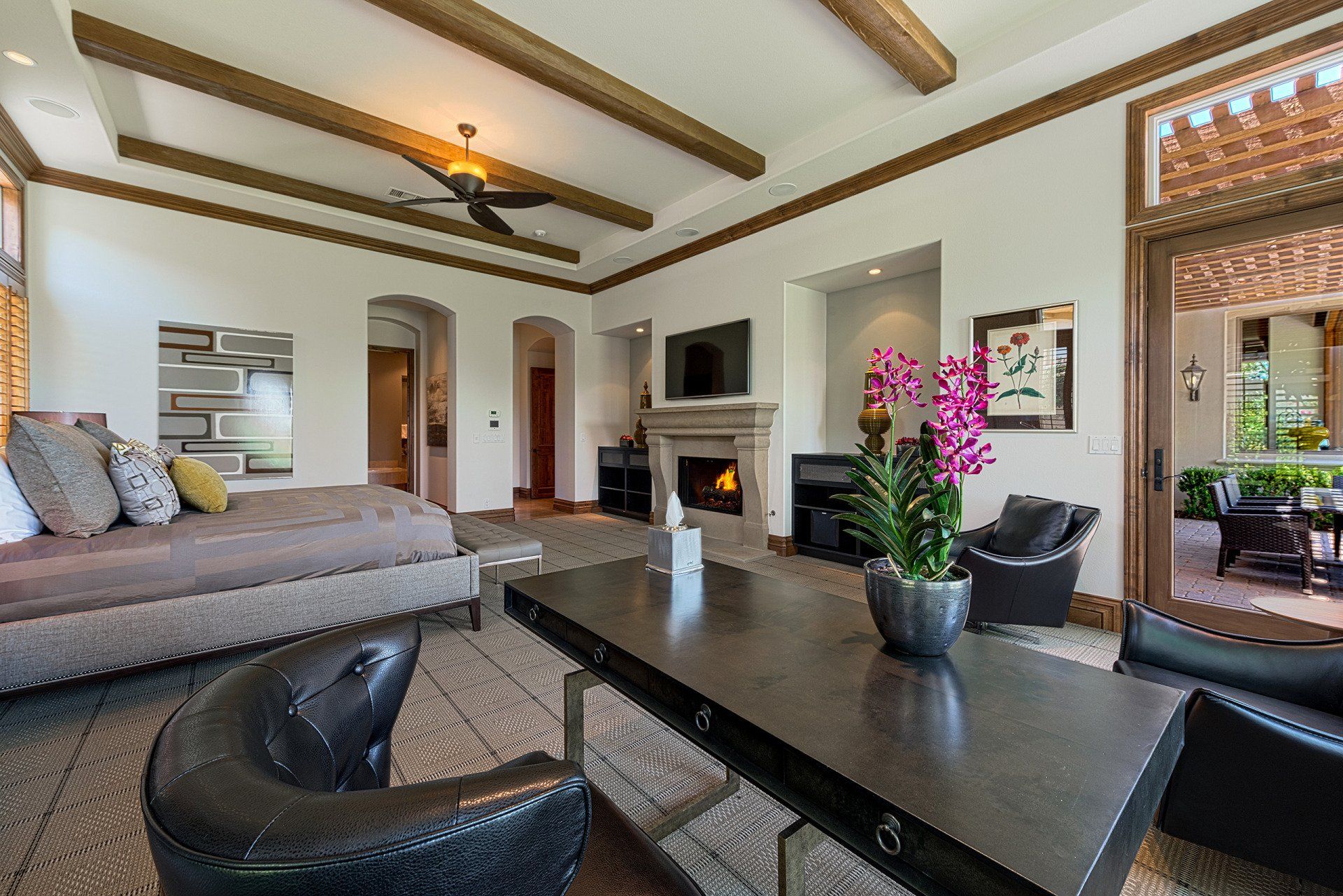 A living room with a table , chairs , and a fireplace.