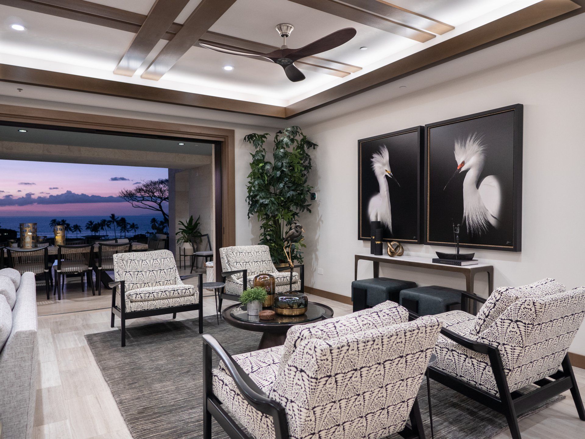 A living room with a lot of furniture and a ceiling fan