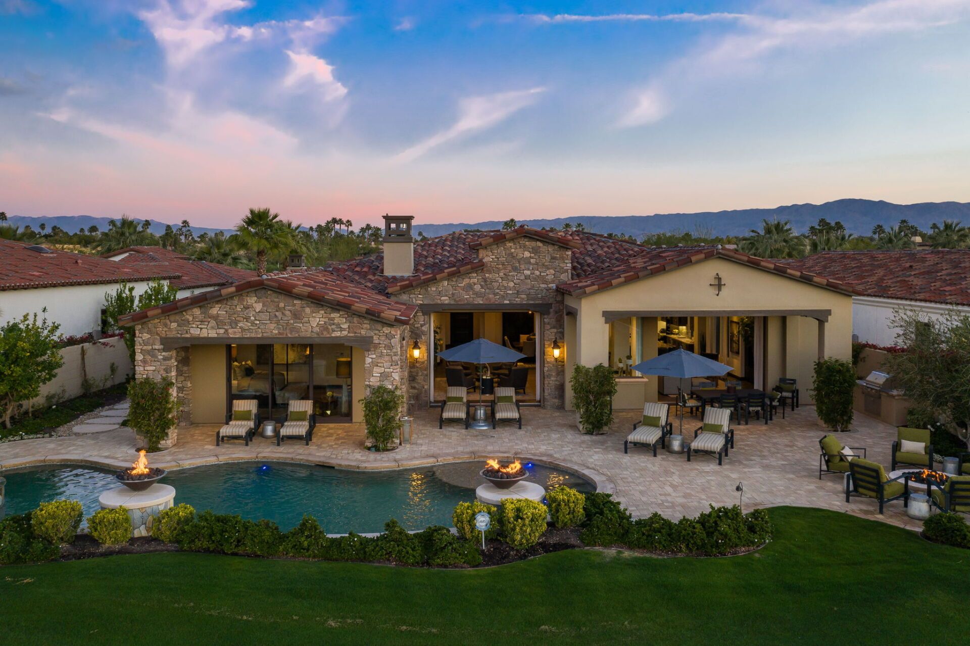 An aerial view of a large house with a swimming pool.