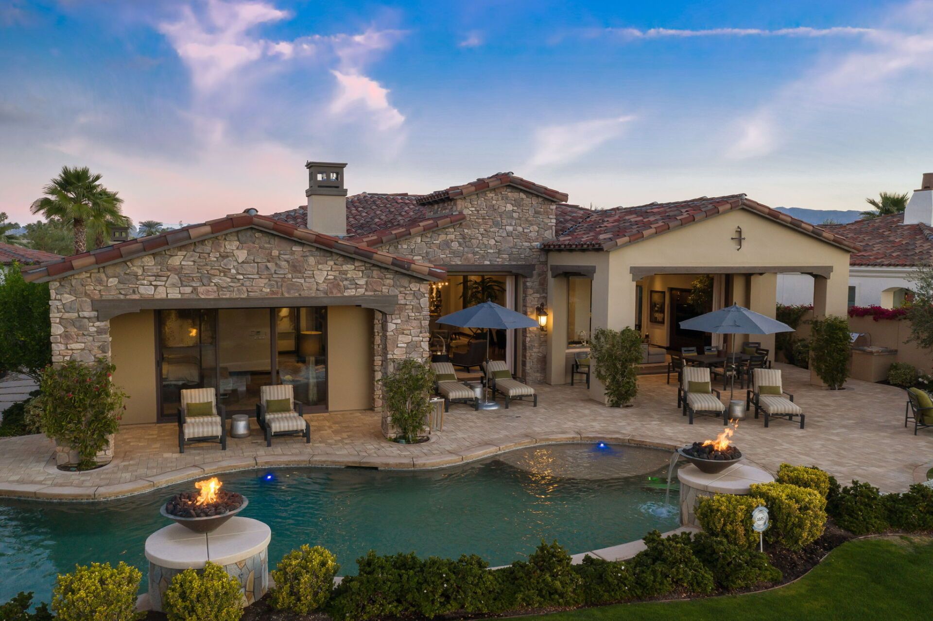 A large house with a swimming pool in front of it