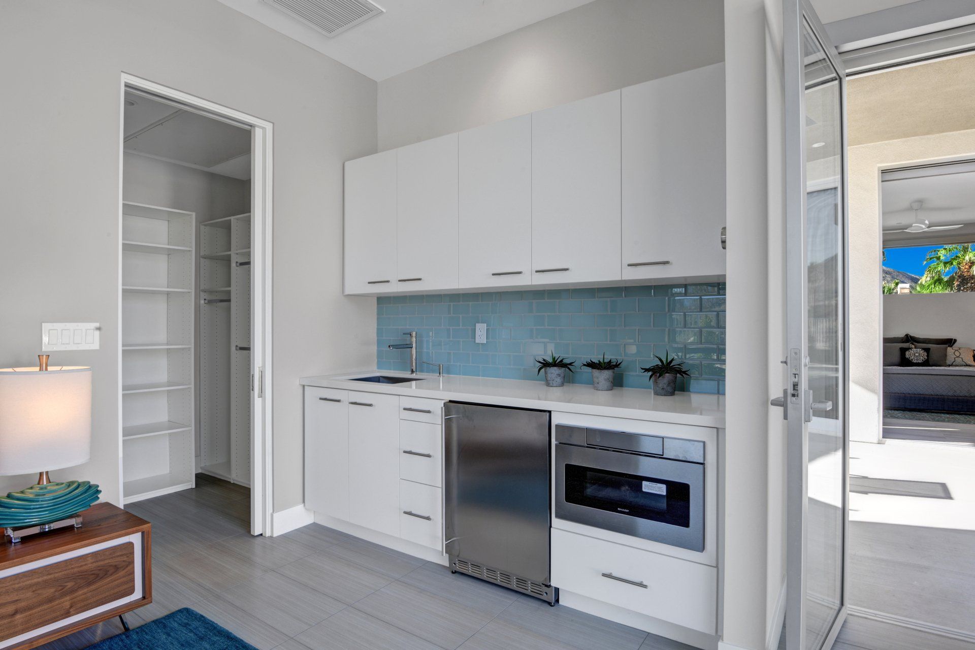 A kitchen with white cabinets and stainless steel appliances.