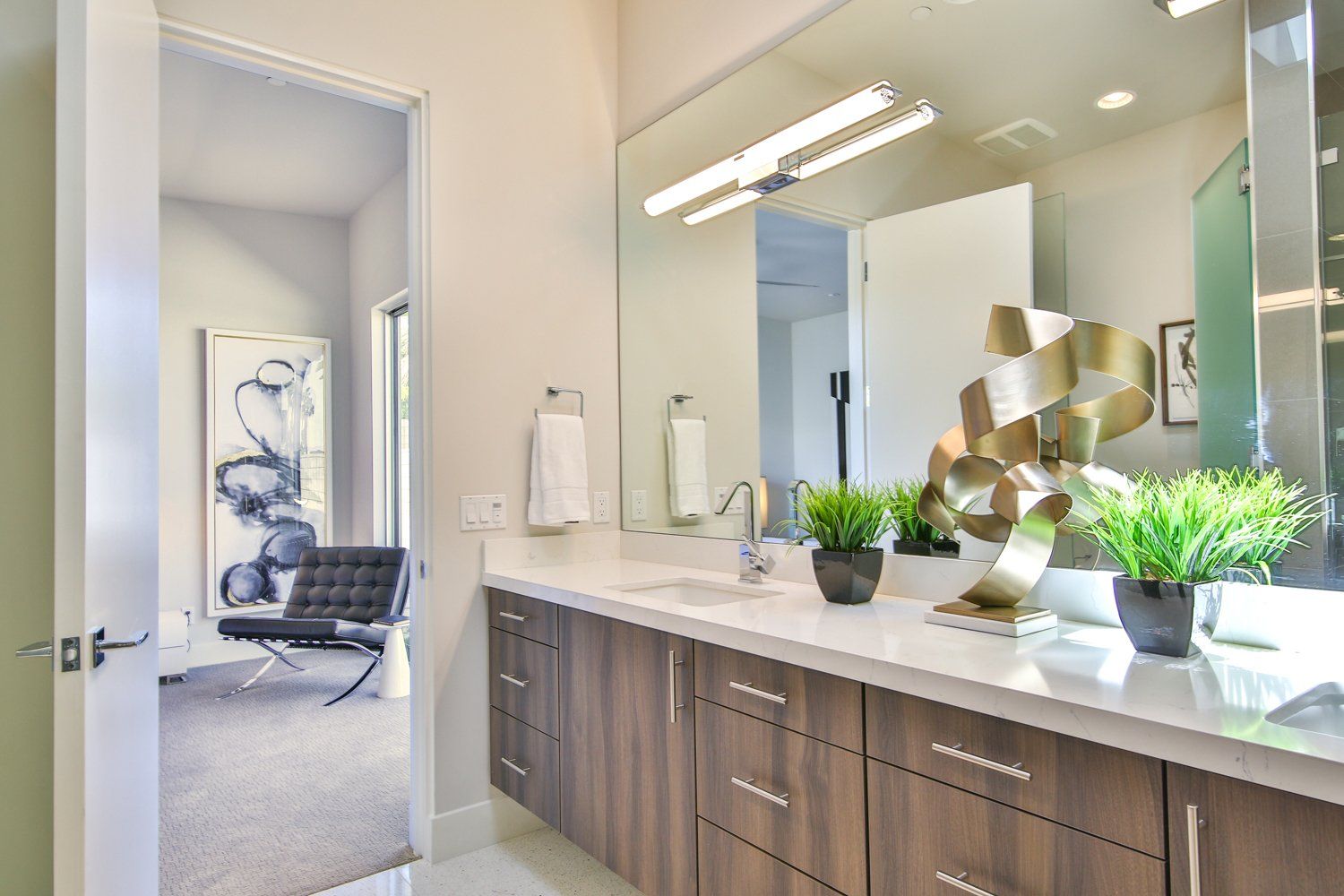 A bathroom with two sinks and a large mirror.