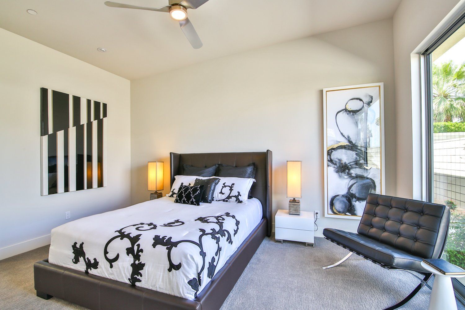 A bedroom with a large bed and a chair